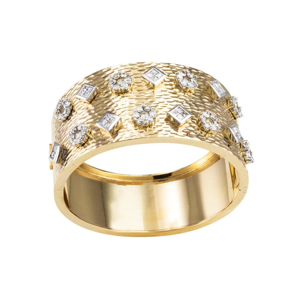 Diamond and yellow gold hinged wide bangle bracelet circa 1980.  Clear and concise information you want to know is listed below.  Contact us right away if you have additional questions.  We are here to connect you with beautiful and affordable
