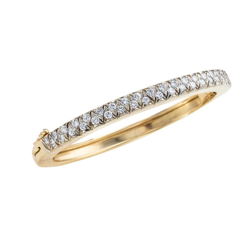 Diamond and yellow gold hinged bangle bracelet circa 1980. Clear and concise information you want to know is listed below.  Contact us right away if you have additional questions.  We are here to connect you with beautiful and affordable