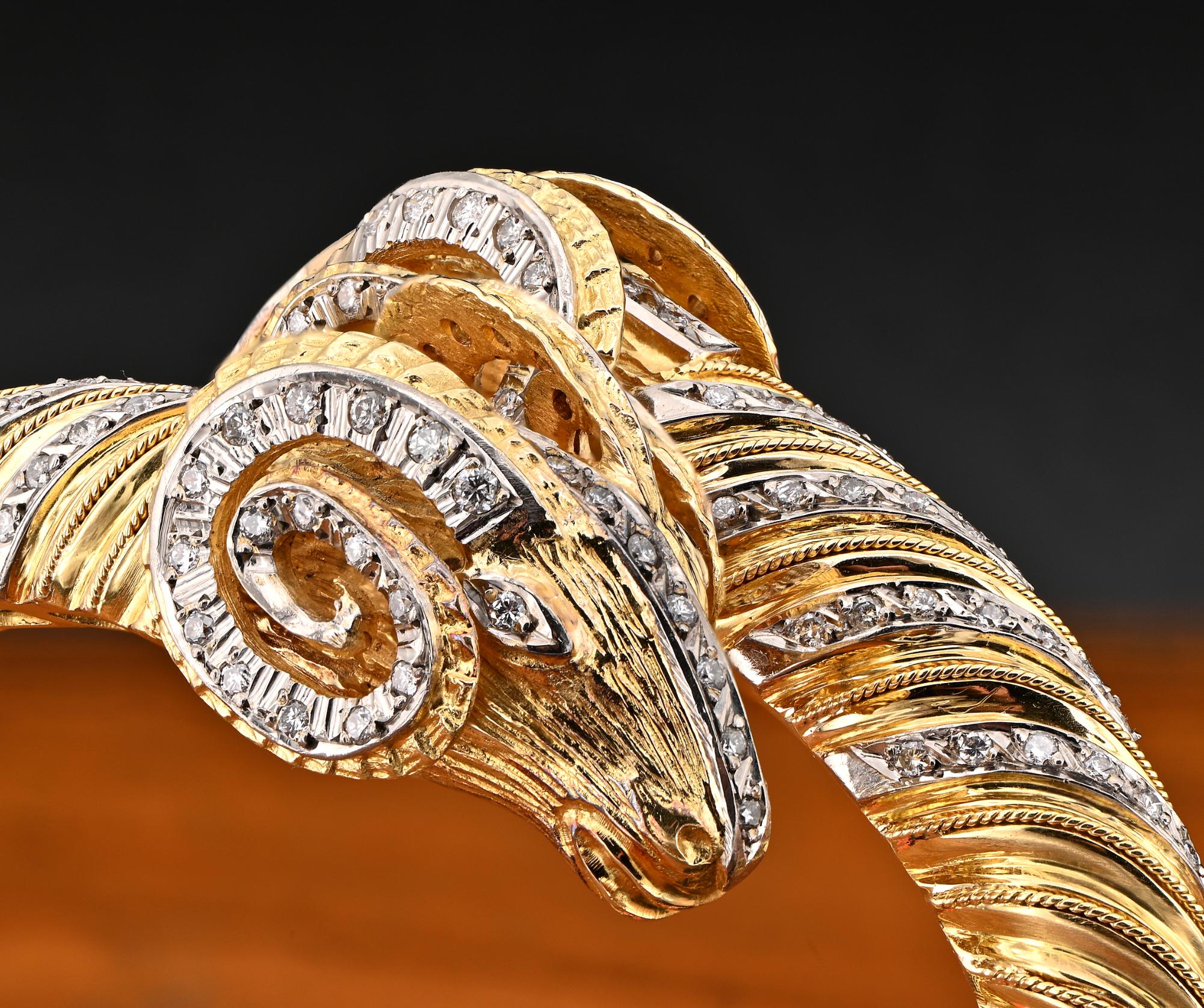Haute Couture
This stunning bangle is 1970 ca., Italian origin
impressive Etruscan style design with two huge Rams head meeting at the center, realistically sculptured, leading to a big twisted work with fine granulating finishing on the edge for an