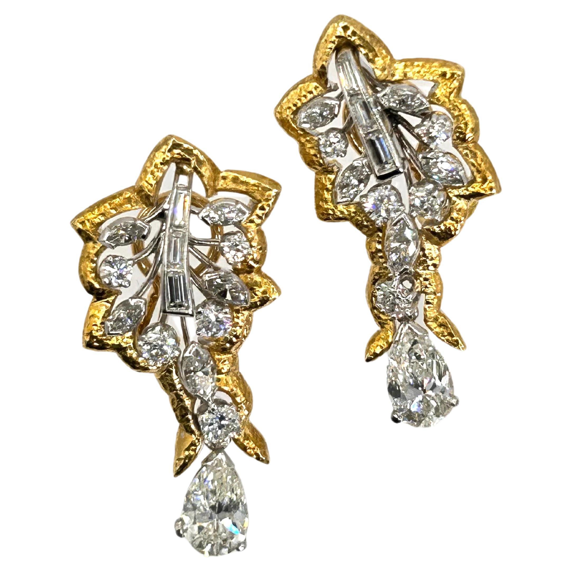 Estate Unique Design 18 Karat Yellow Gold and Platinum Earrings.
The Earrings have 2 Pear Shape Diamonds of 2.02 Carat Total Weight with average Clarity of VS and average Color of J.
Also containing 1.50 Carat Total Weight of Marquise, Round