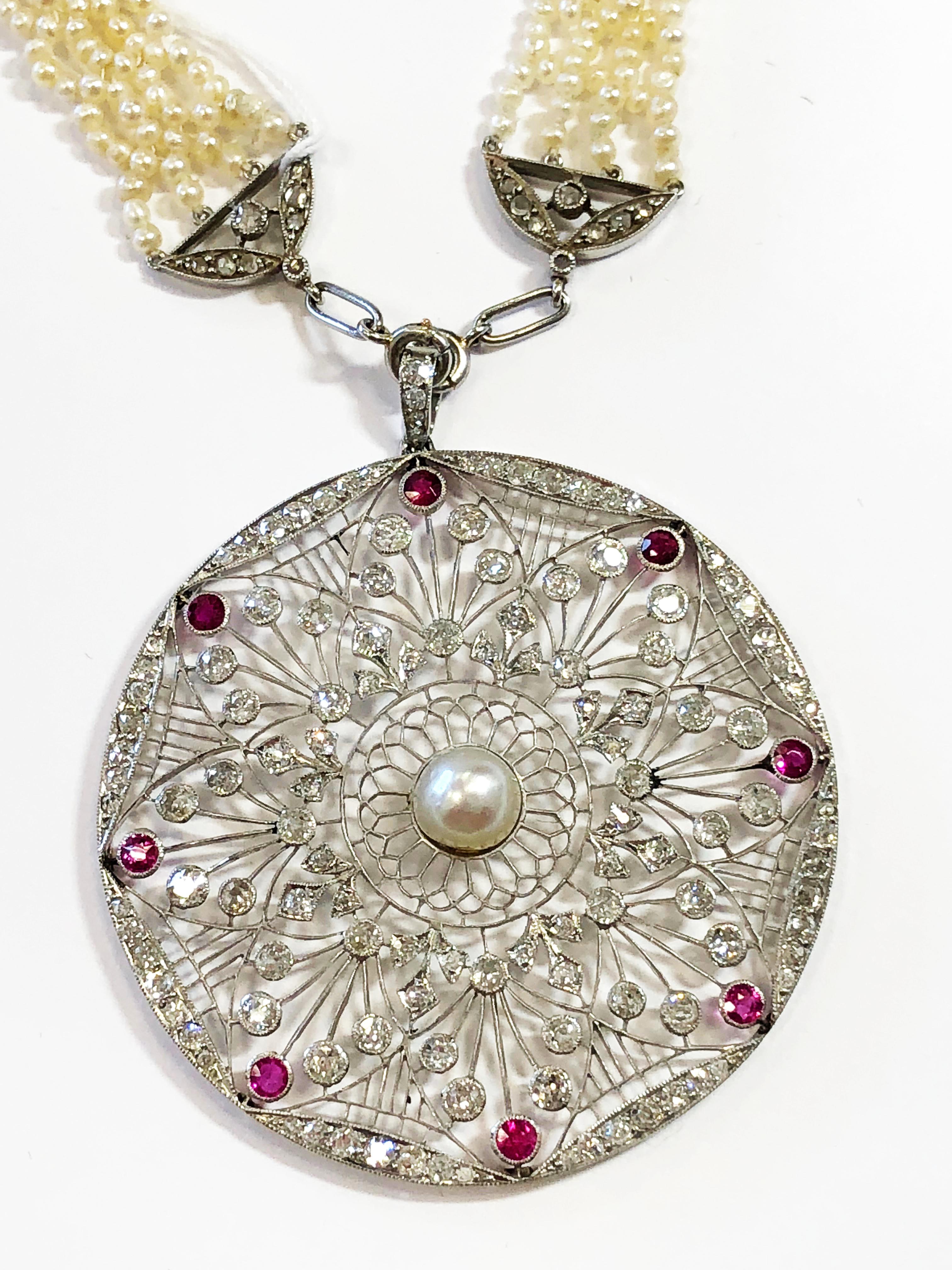 Breathtaking Edwardian estate natural white pearl and white diamond necklace.  Gorgeous pendant/medallion design with delicate handwork.  This piece is unique because it has a mix of natural pearls, with metal, diamonds, and color stones.  Ideal for