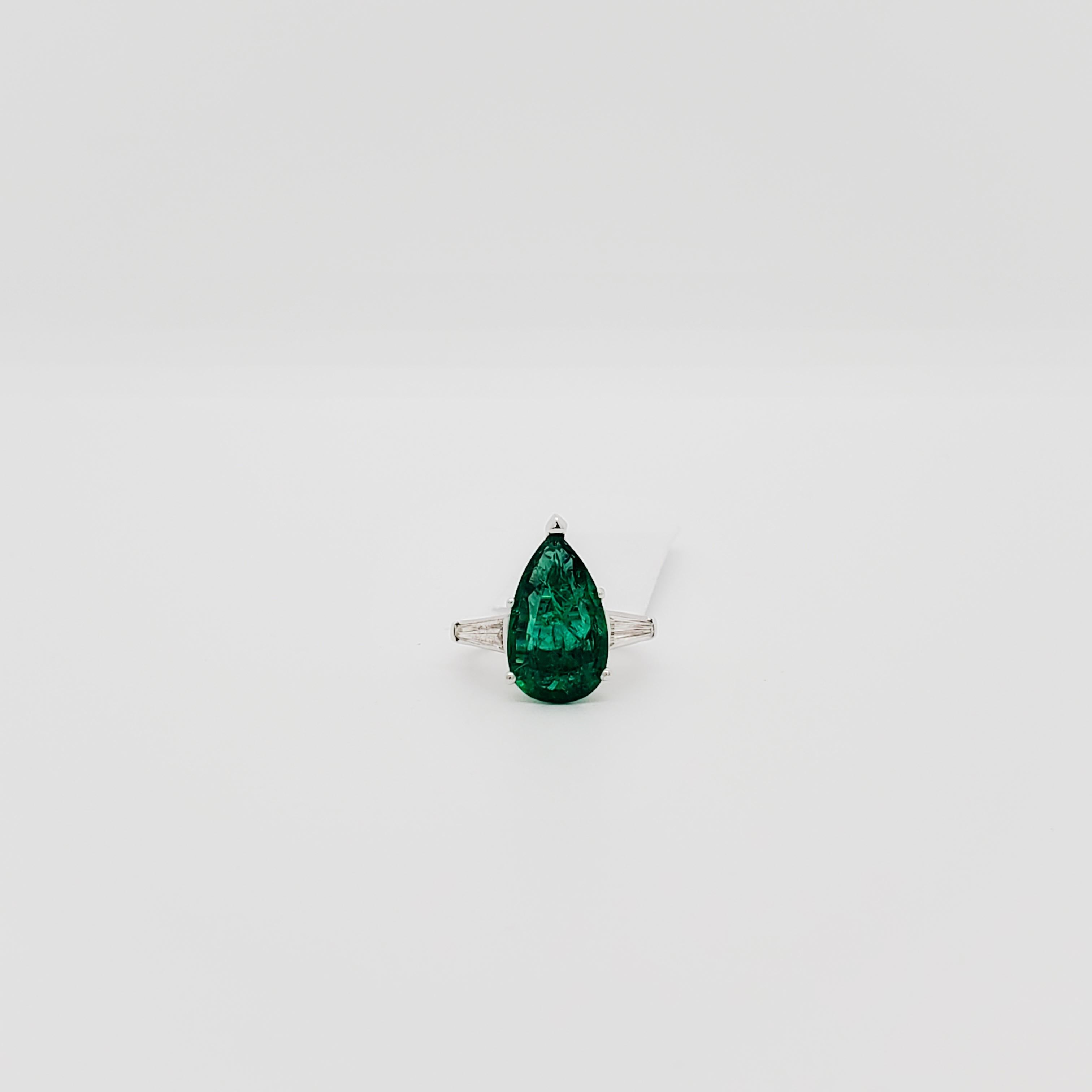 Beautiful deep green 3.70 ct. emerald pear shape with 0.30 ct. white diamond baguettes.  Handmade in platinum.  Ring size 3.  Can be easily resized.