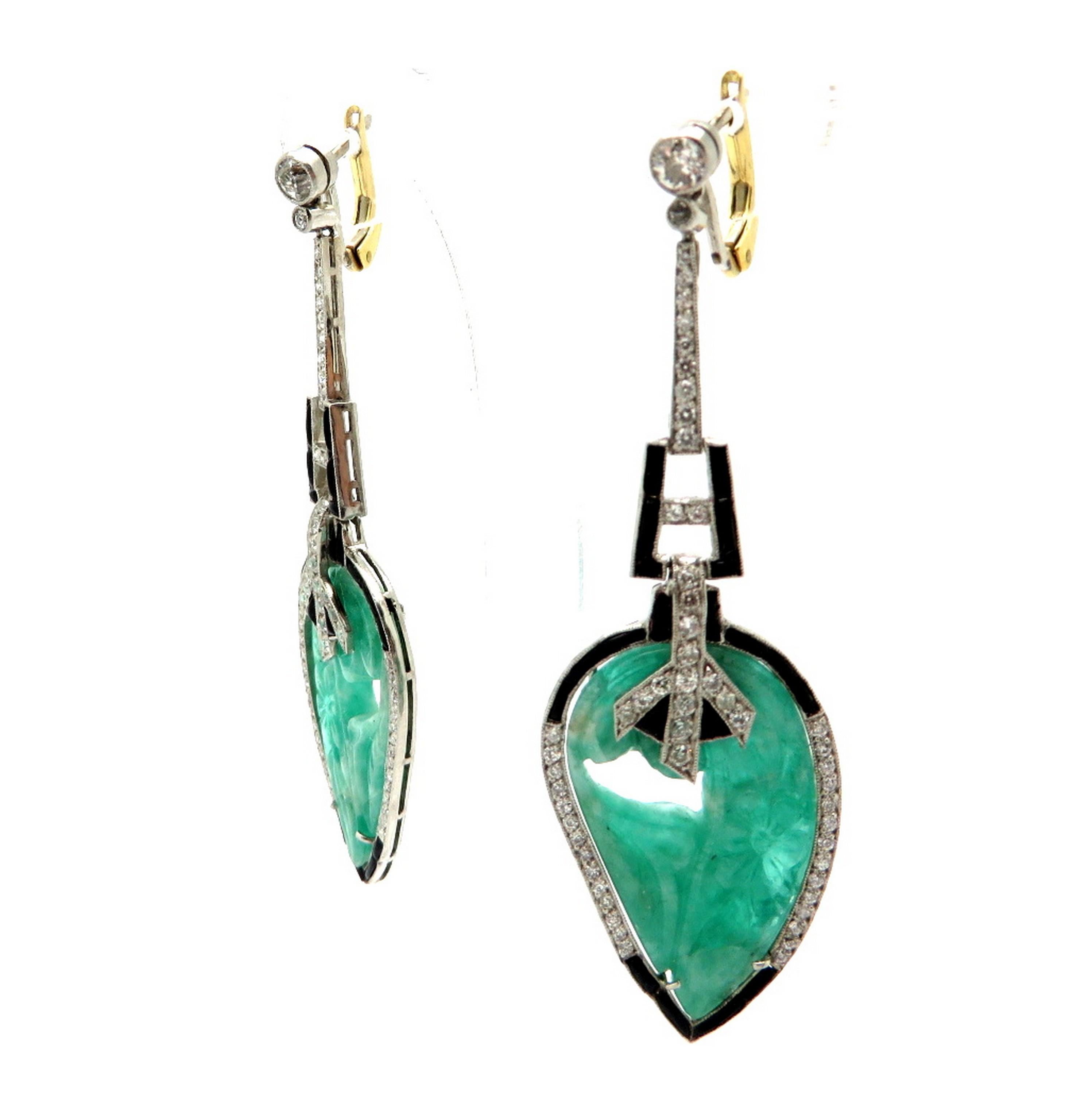 Estate emerald and diamond platinum Art Deco style leaf dangle earrings. Showcasing 2 fine quality carved emeralds with a leaf motif. Accented with 110 Old European cut bead and bezel set diamonds, weighing a combined total of approximately 1.55