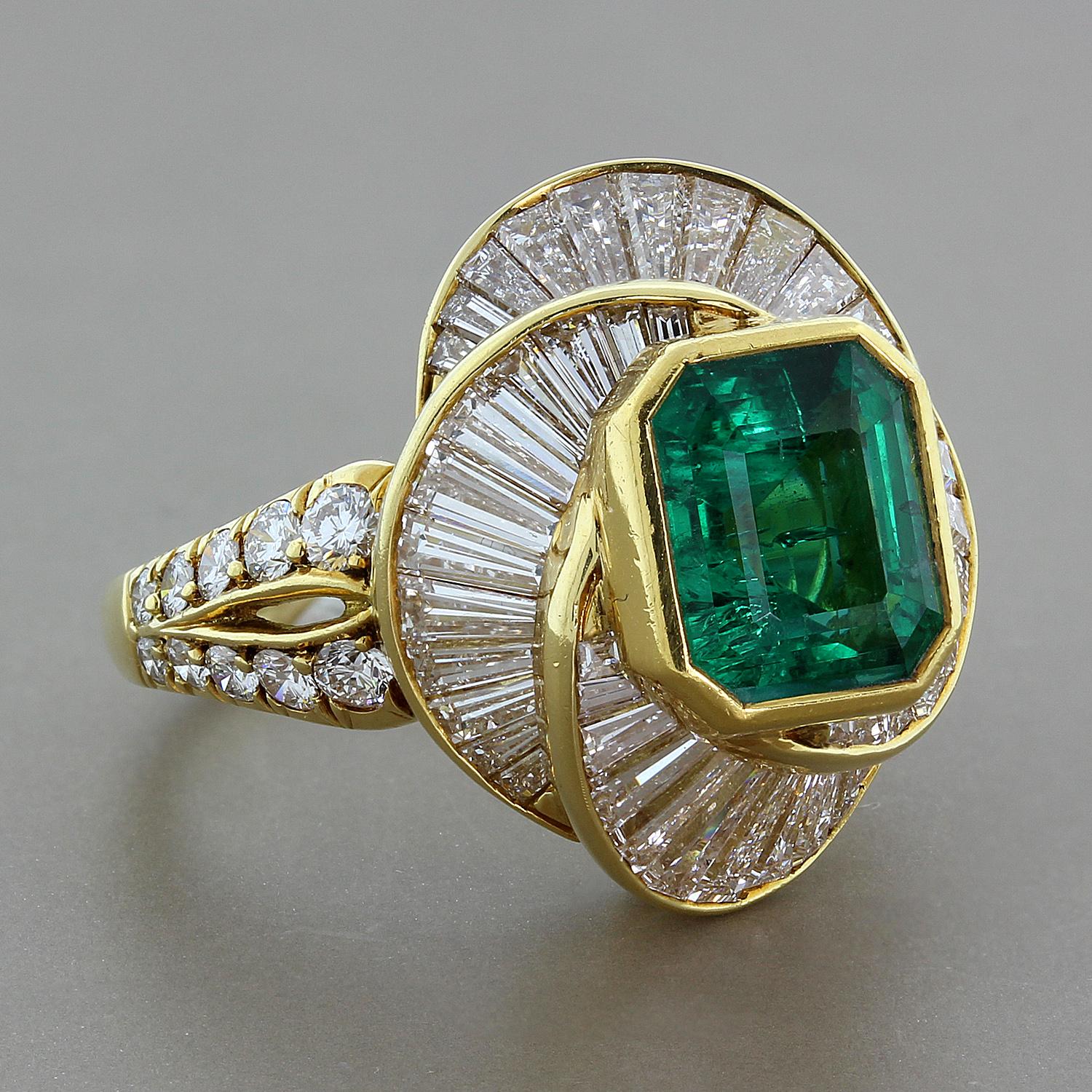 An estate sparkler with a 4.32 carat emerald cut emerald.  Bezel set and surrounded by a swirl of 4.70 carats of baguette cut diamonds and round cut diamonds on a split shank of 18K yellow gold.  Based on the vivid green color of the emerald, our in