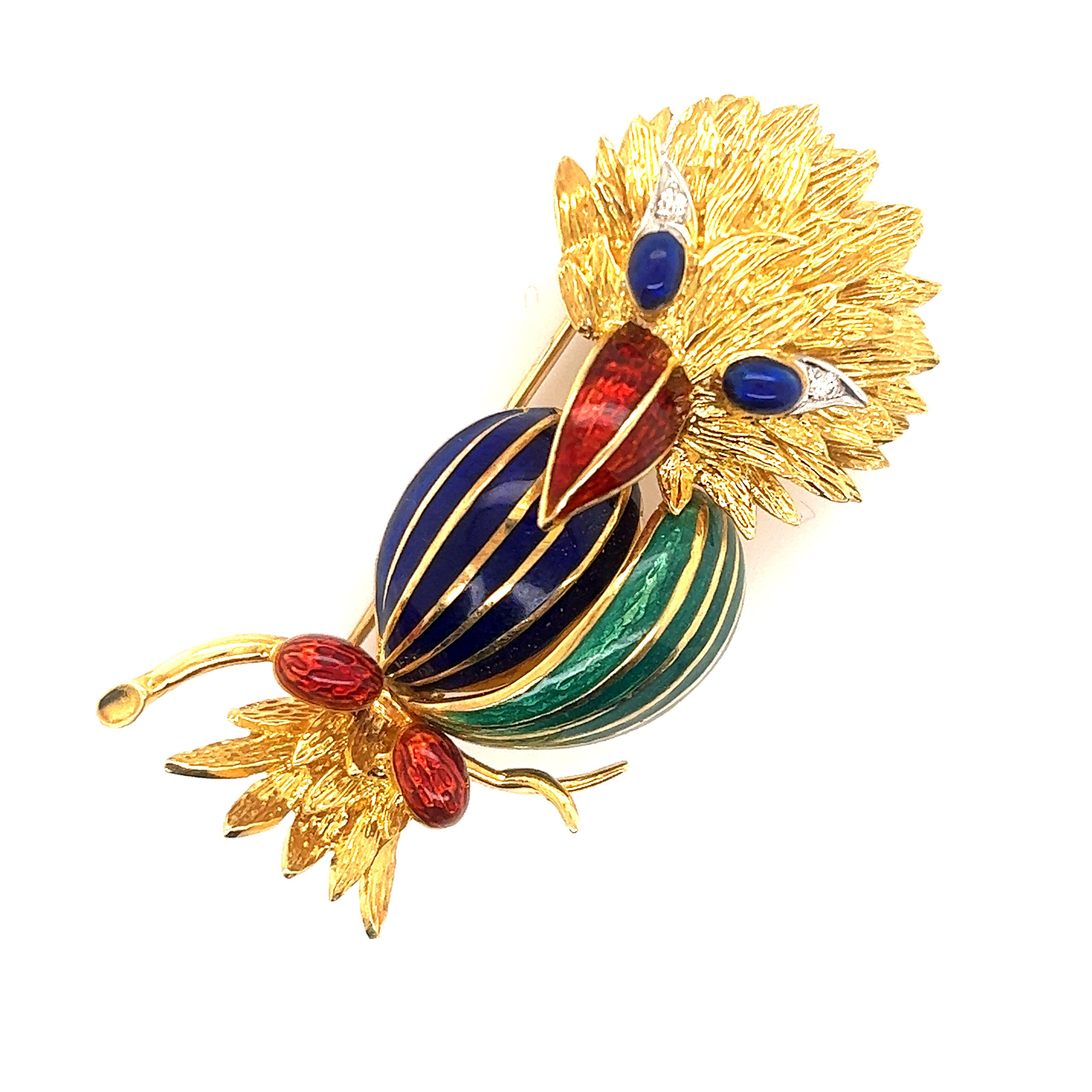 Fantastic design seen on this beautiful brooch. The brooch is crafted in the theme of a bird with details seen throughout. Vibrant shades of blue, green and red enamel decorate the bird. Diamond accents are seen in the eyes. The brooch is crafted in