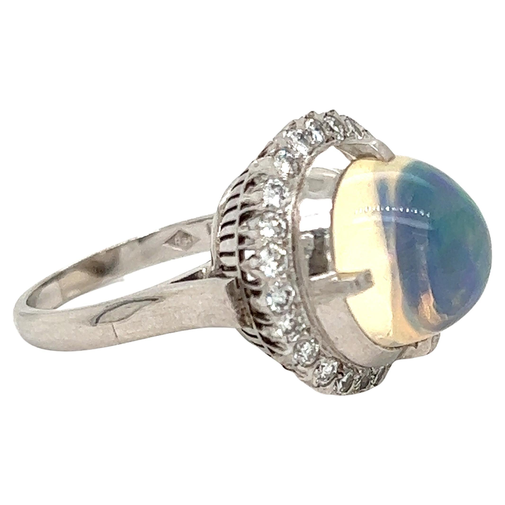 This giant opal and diamond ring is to die for! 5.43 carats of vibrant opal is the centerpiece of this ring, surrounded by 0.90 ctw of diamonds with VS-SI clarity and G-H color. All of the stones are set in 9.00 grams of platinum. 
