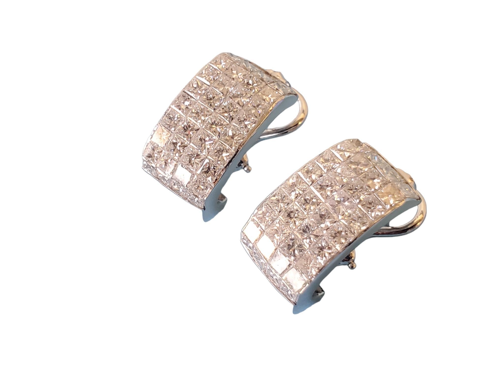 Listed are these amazing invisible set diamond earrings. These earrings feature 40 invisible set princess cut diamonds in each earring for an approximate total weight of 6.5 carats for the set. The diamonds are white GH VS-SI quality very nice