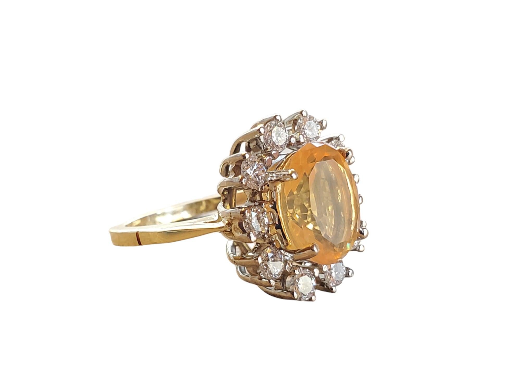 This listing is for an estate fire opal diamond ring in 18k yellow gold and white basket. The center opal is 2.11ct, orangey translucent and beautiful. The surrounding diamonds are all excellent cut colorless vs diamonds at 1tcw. Approx. size 6,