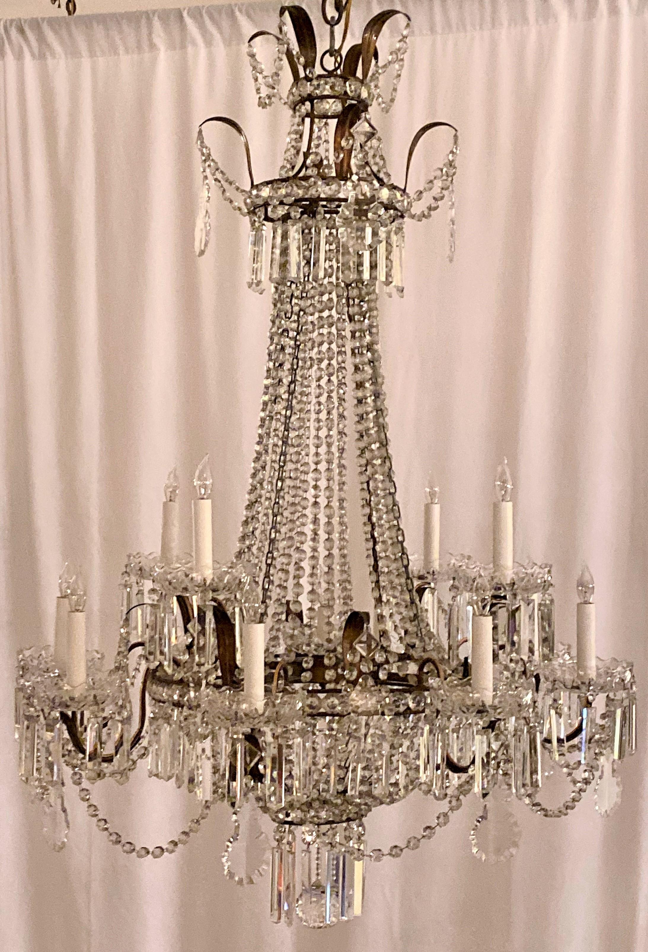 Estate French Empire style cut crystal and tole 12-light chandelier, circa 1930s-1940s.
This is a very handsome chandelier, heavily draped with cut crystal prisms and crystal beading.
 