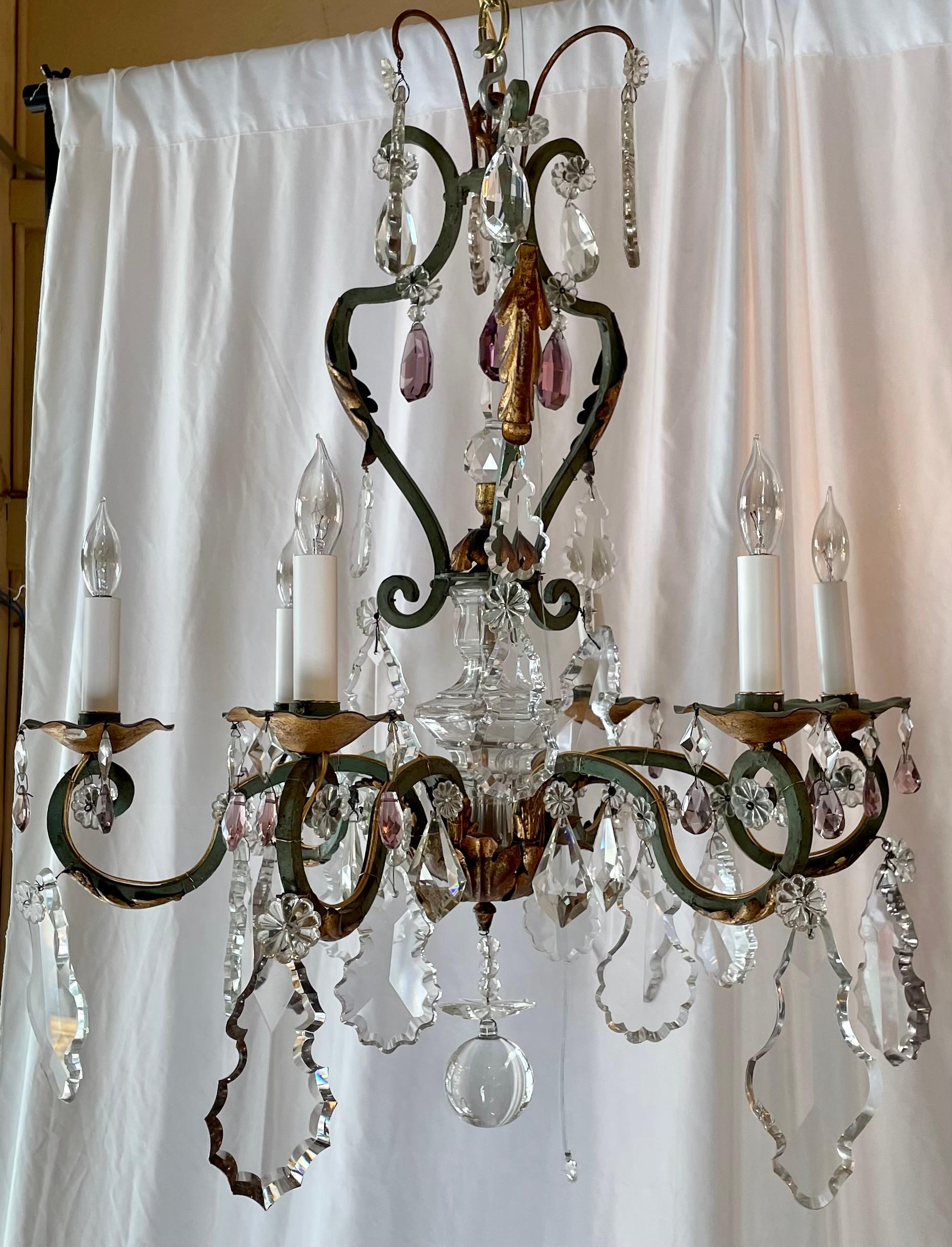 Estate French Wrought Iron and Clear & Multi-Colored Cut Crystal Chandelier, Circa 1920's.
Patinated and Antique Gold Iron Frame with Amethyst, Amber and Clear Prisms. 