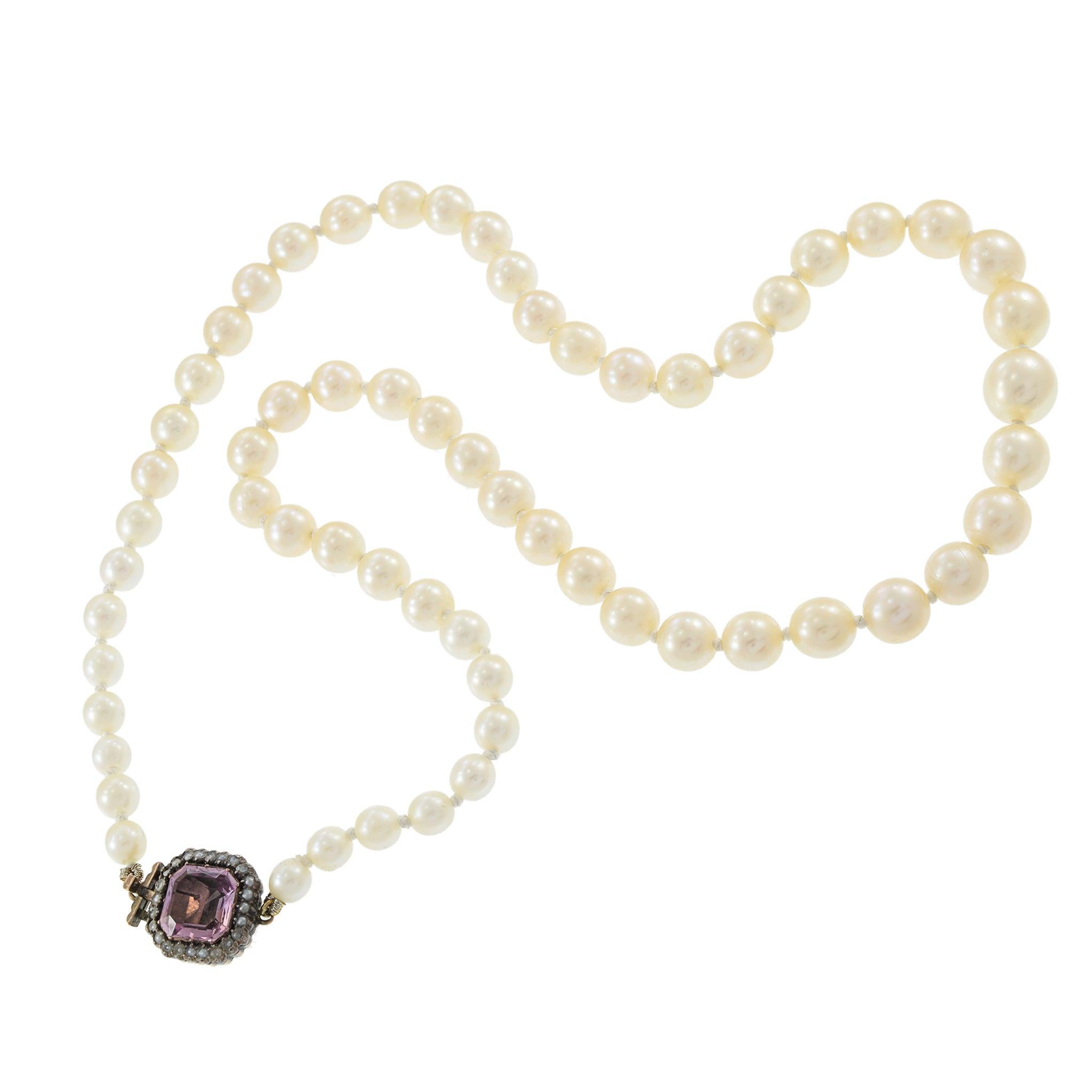 This beautiful estate necklace features genuine Japanese Akoya pearls ranging from 5mm to 9mm in size, arranged in a graduated design. The 20-inch necklace is finished with a 9KT gold clasp adorned with pink tourmaline and a pearl, adding a touch of