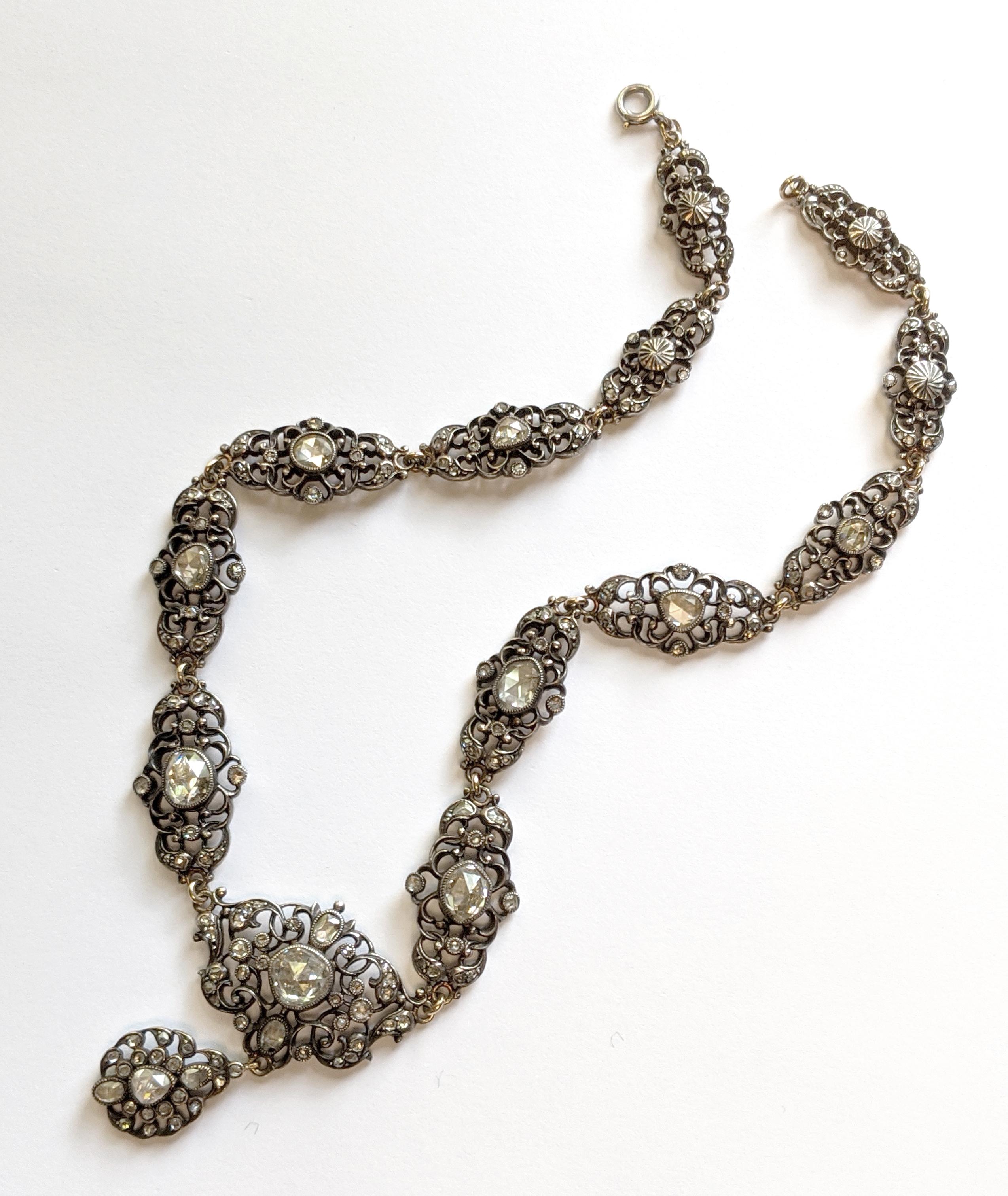One silver over 18 K yellow gold Georgian-style necklace containing approximately 203 rose cut diamonds weighing approximately 6.17 carats in total. The necklace measures 15 inches in length and is finished with a platinum spring ring. The necklace