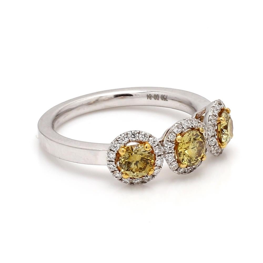 18K yellow/white gold diamond ring. Center stone is one (1) round brilliant cut, fancy deep brownish-greenish-yellow diamond weighing 0.30ct. Center stone is accompanied by GIA CVolored Diamond Report #2173586010. Ring is also set with two (2) round