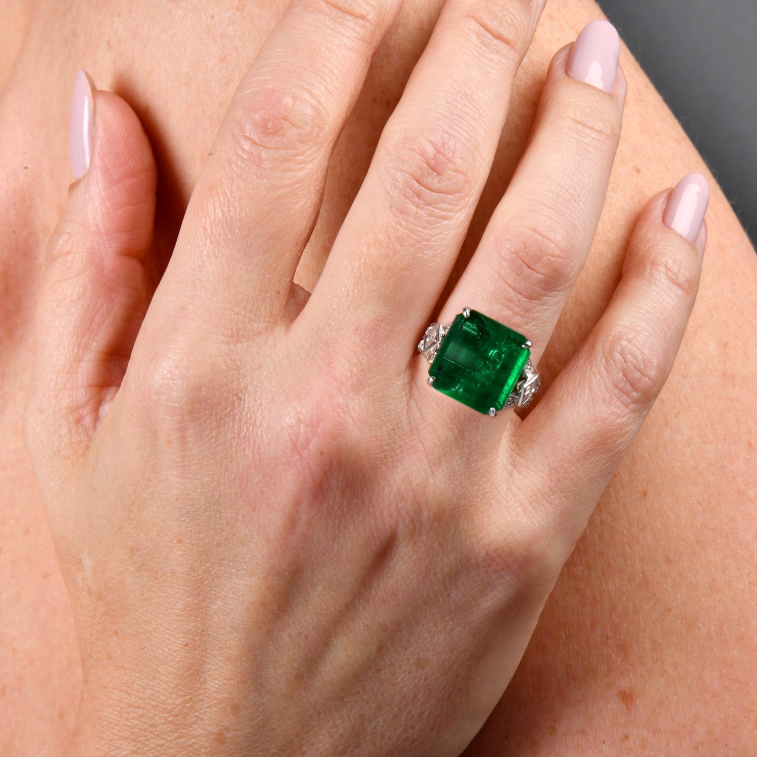 Featuring the splendor of this GIA-certified emerald engagement ring, elegantly set in platinum.

The Art Deco Design ring centered approx. 4.75-carat  emerald, adorned by 40 prong-set round diamonds and flanked by square step-cut diamonds in a