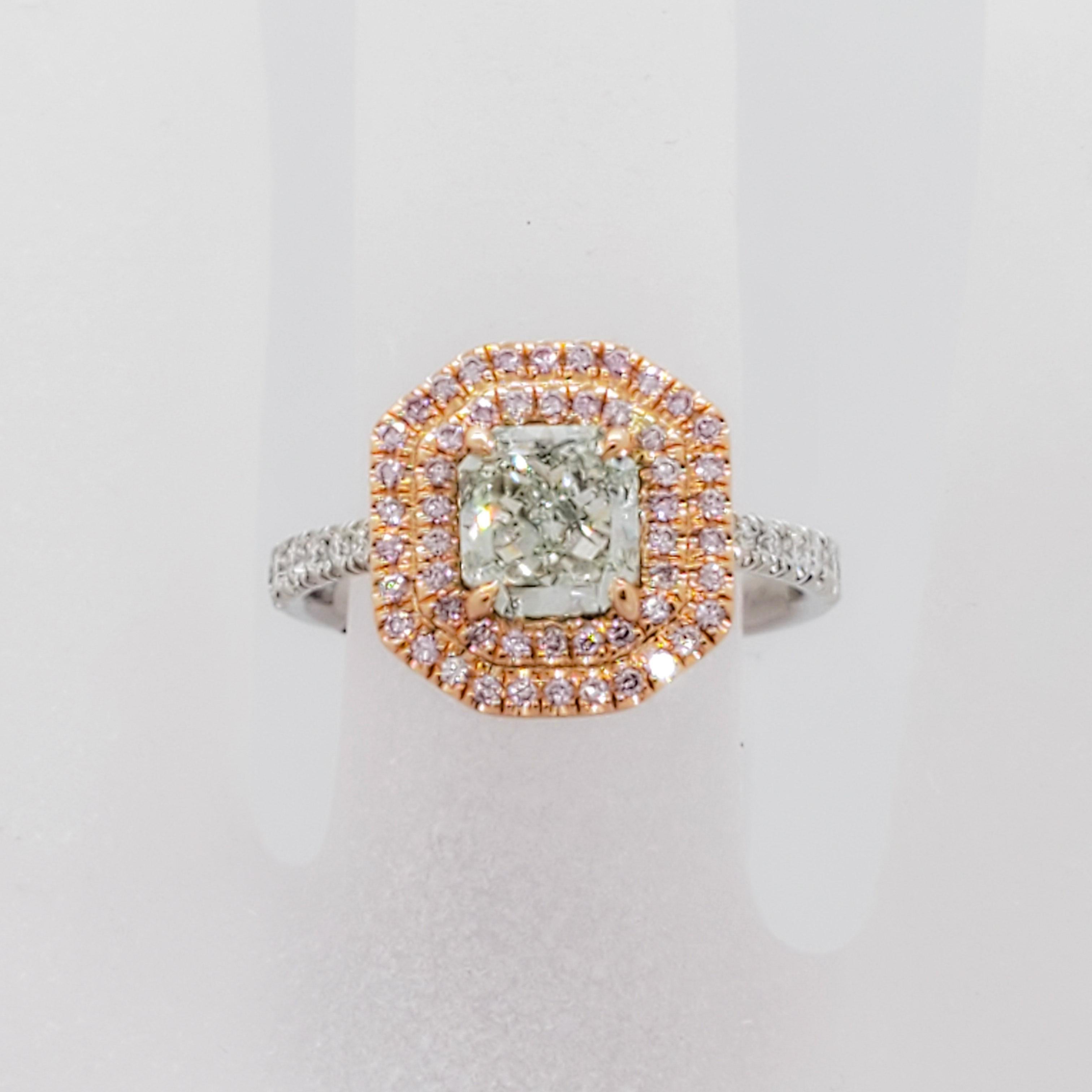 Astounding 1.10 ct. fancy green diamond radiant, VS2 clarity.  Surrounding the green diamond are 2 rows of 0.25 ct. of natural bright pink diamond rounds in a handmade platinum and 18k rose gold mounting.  Ring size 6.25.  Excellent condition. GIA