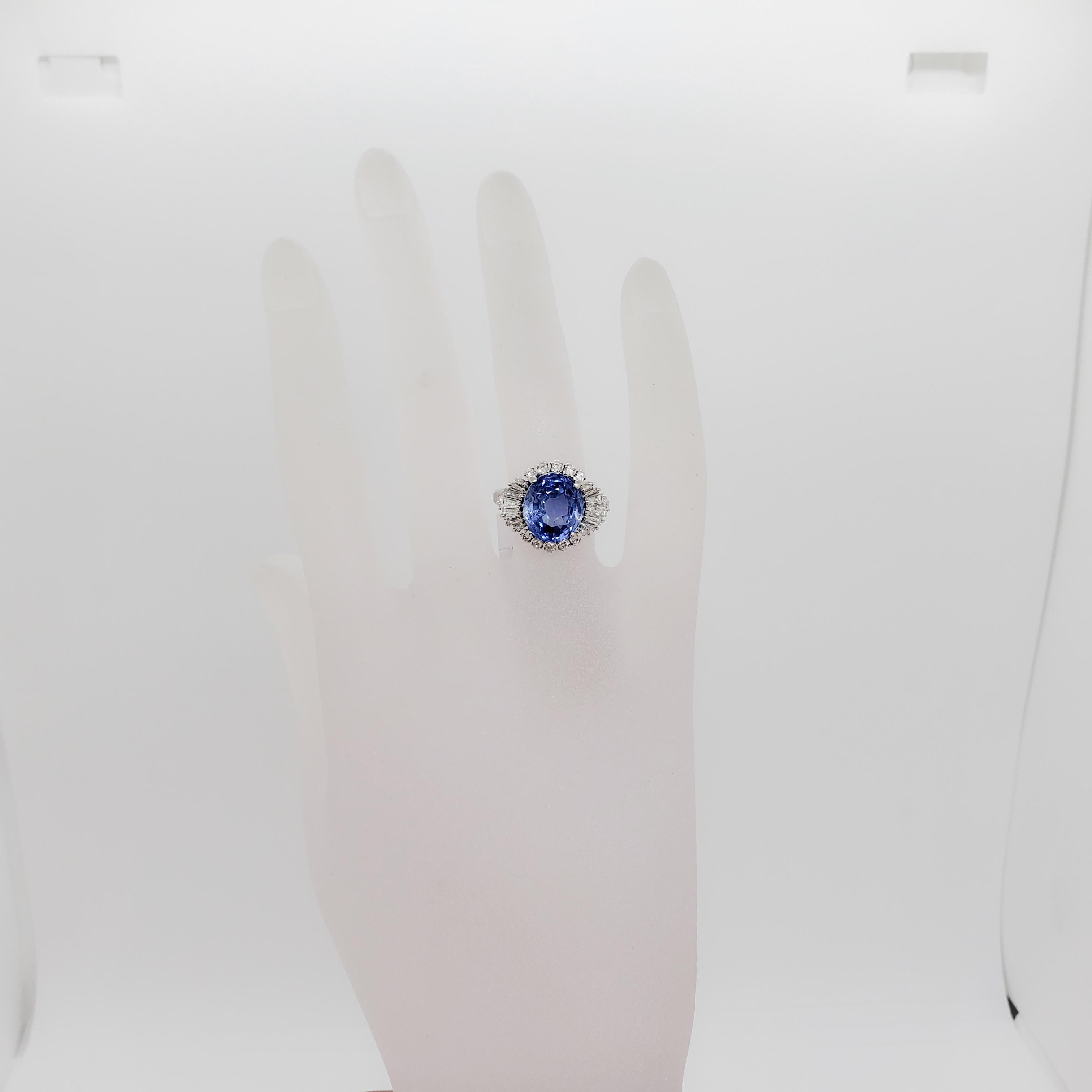 Gorgeous bright blue color 6.66 ct. Sri Lanka blue sapphire oval with 0.80 ct. of good quality, white, and bright diamond baguettes and rounds.  Handmade mounting in platinum.  Ring size 6.75.  Comes with GIA certificate.