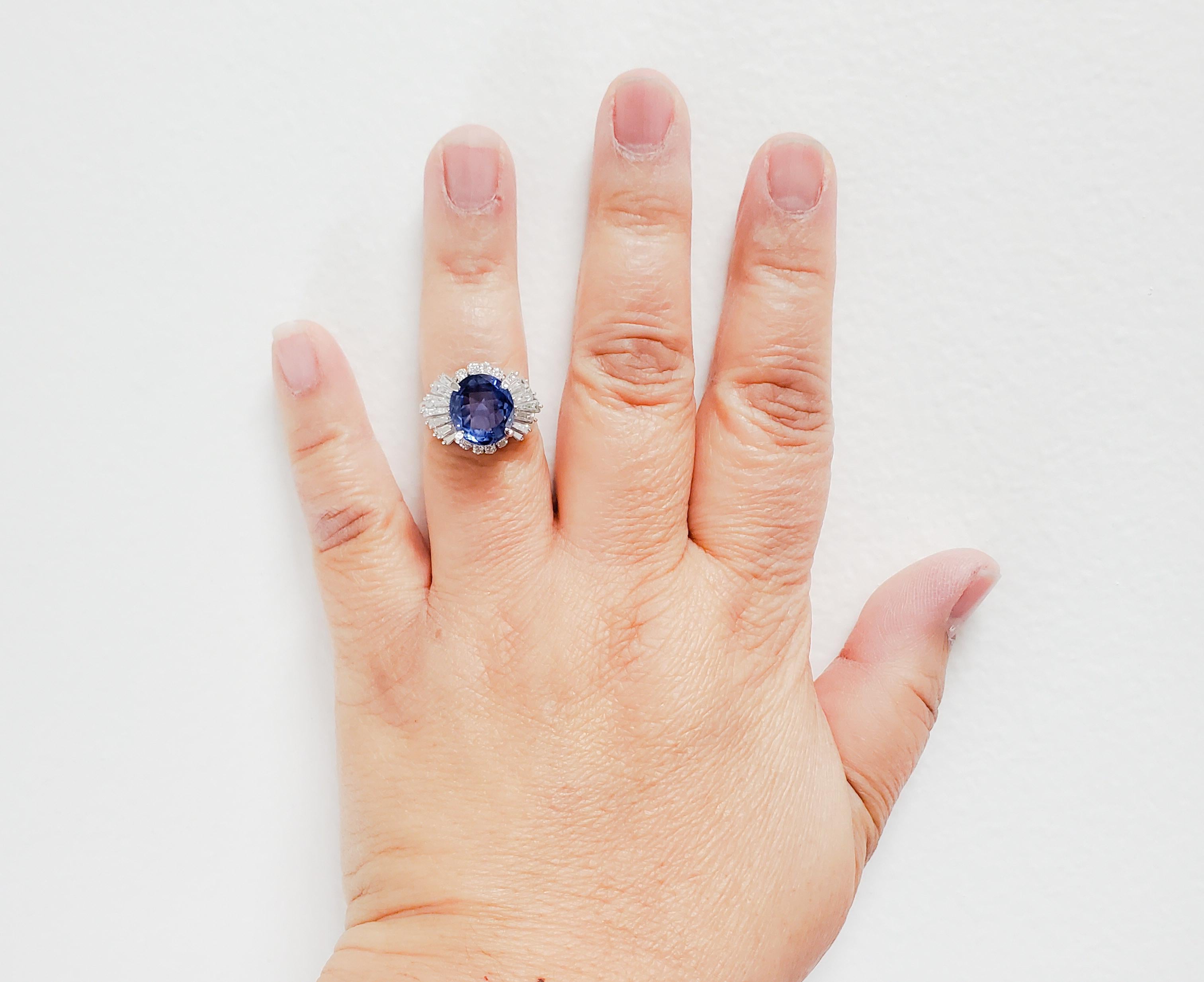 Gorgeous deep blue unheated blue sapphire oval weighing 5.53 ct. with 1.51 ct. of good quality white diamond rounds and baguettes.  Handmade platinum mounting in size 7.  GIA certificate is included.