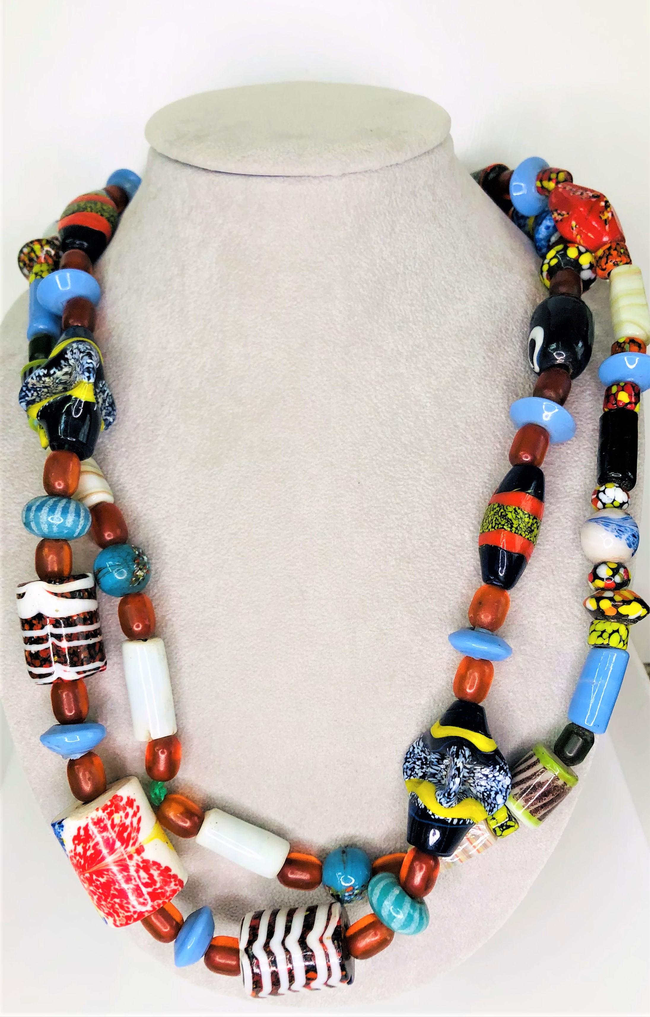 This unique necklace will match lots of clothing and be admired by all!  
It is a piece of wearable art!
99 pieces of varying shapes and colors.
Approximately 53 inches long.
Largest bead is approximately 22mm x 29mm
Smallest bead is approximately