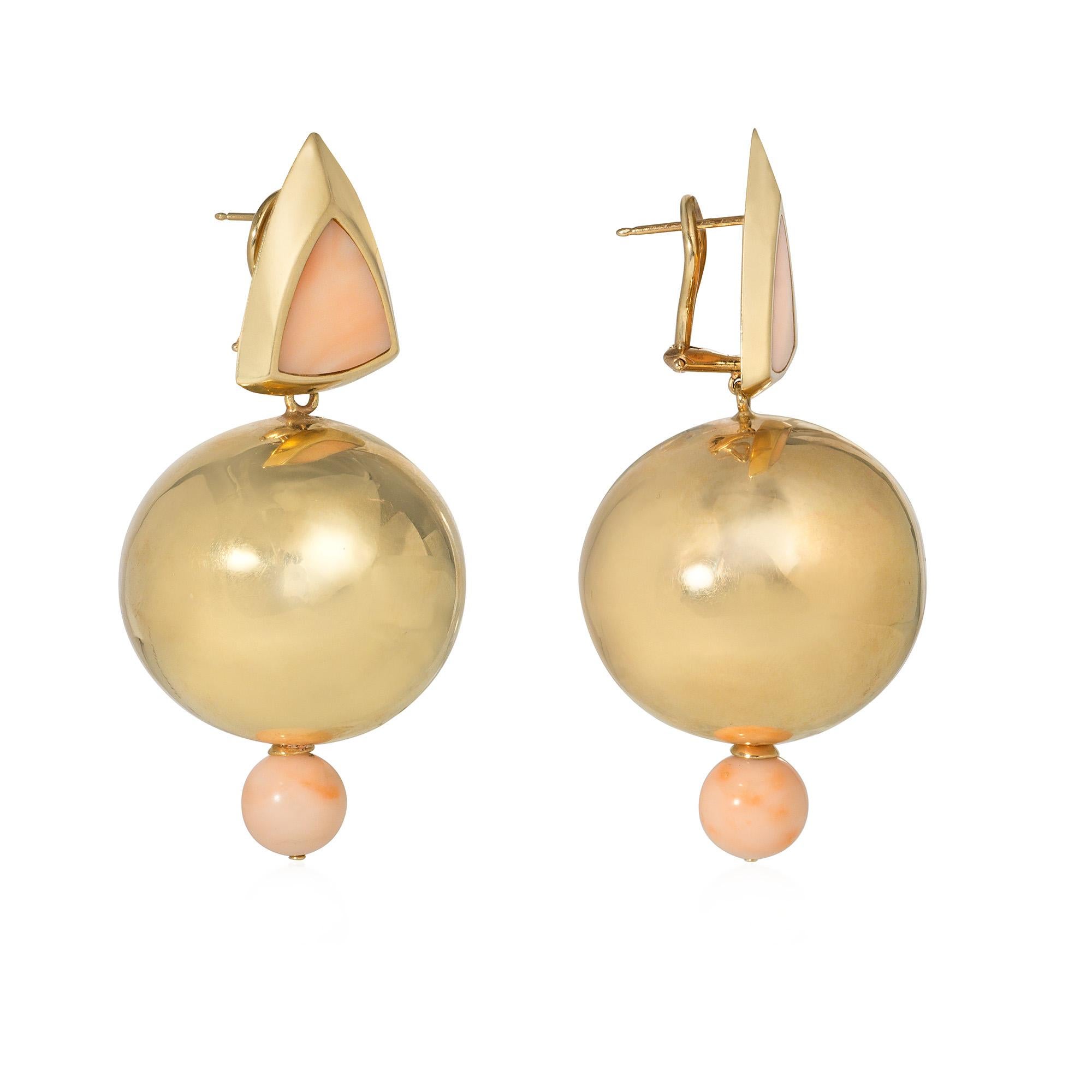 A pair of estate gold and coral Memphis style earrings of geometric motifs, comprising triangular gold surmounts inset with angel skin coral, suspending oversized gold bead pendants of 32mm each, with small angel skin coral bead terminals, in 14k