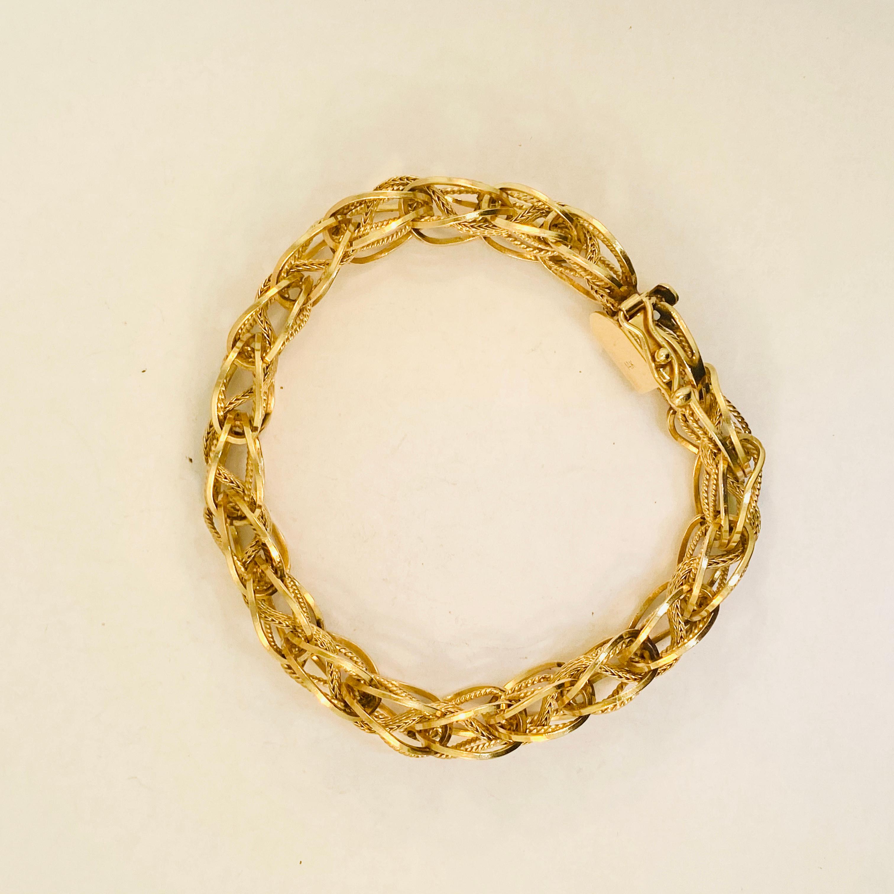 This 14 karat solid yellow gold bracelet is one of a kind and has some of the most intricate chain work I've seen!  The bracelet can be worn by itself or it could be worn as a charm bracelet. This piece is perfect for daily wear or a night out! 

14