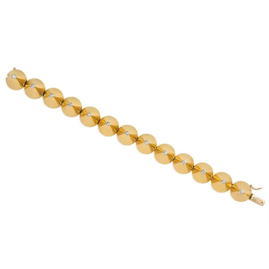A gold bracelet comprised of cone-shaped links with diamond terminals, in 18K and platinum.