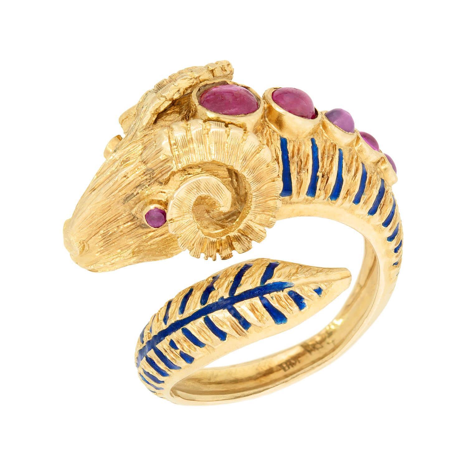 A fabulous Estate ram's head ring! This piece is crafted in 18k yellow gold, and has a 3-dimensional design. It depicts a stately ram, whose head rests prominently at the top, its body wrapping around to form the band. Luscious rubies line the top