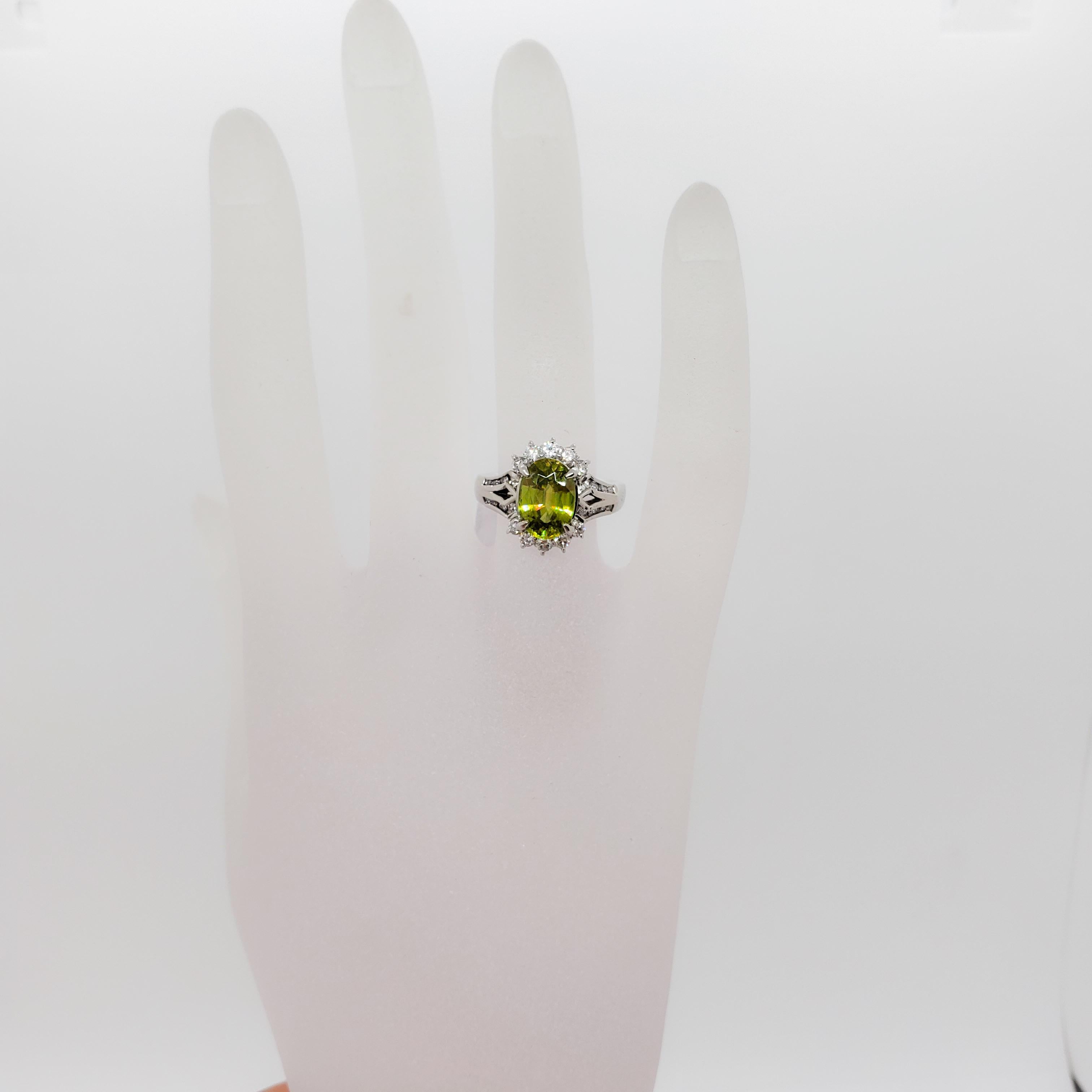Stunning green sphene oval weighing 2.88 ct. with 0.64 ct. of good quality white diamond rounds.  Handmade platinum mounting in ring size 6.5.  Beautiful classic design that can be worn everyday or for a special occasion.  Mint condition.