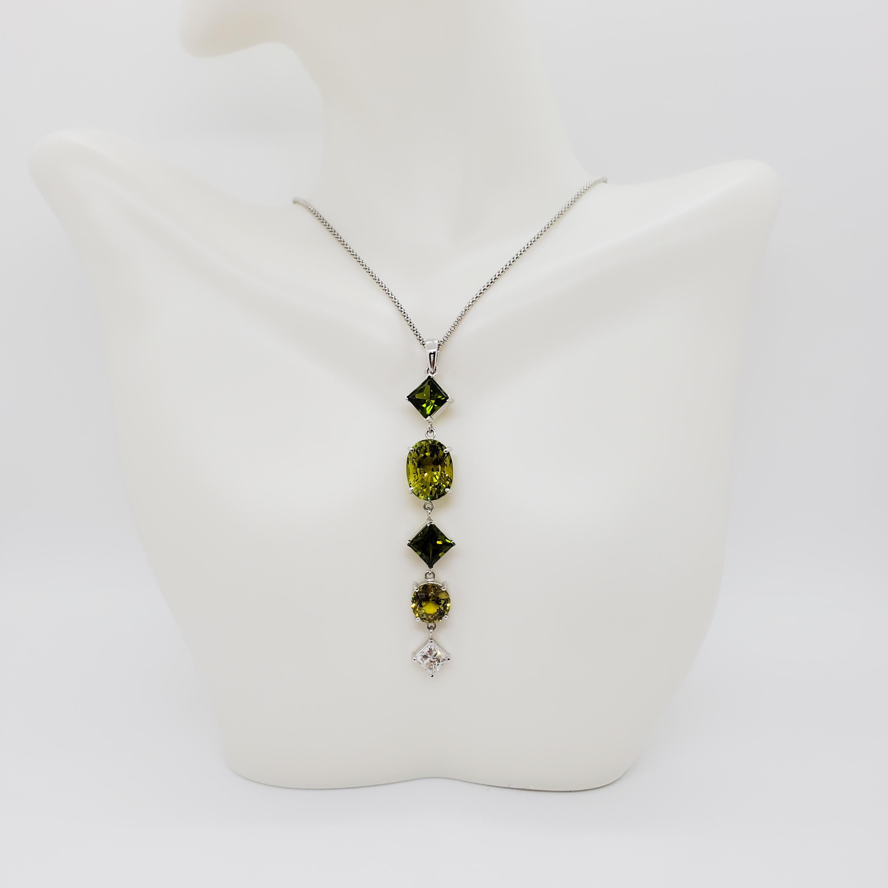 Beautiful necklace showcasing a 8.52 ct. green tourmaline oval and two 7.70 ct. green sphene stones.  0.93 ct. good quality white diamonds. 18