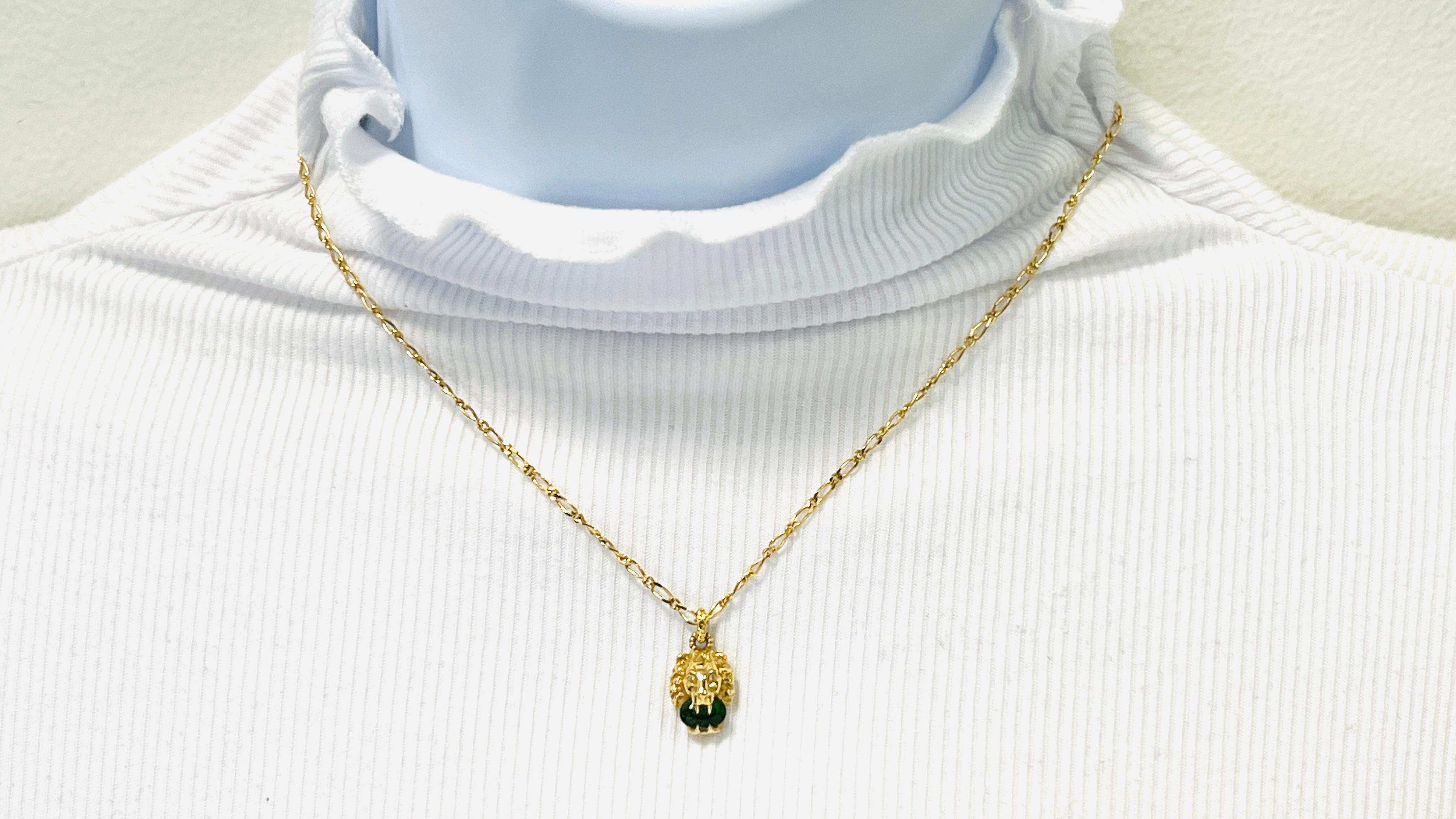 Beautiful estate Gucci necklace and earrings set made out of 18k yellow gold.  The design is of a lion's head holding a green gemstone.  Length of necklace is 16