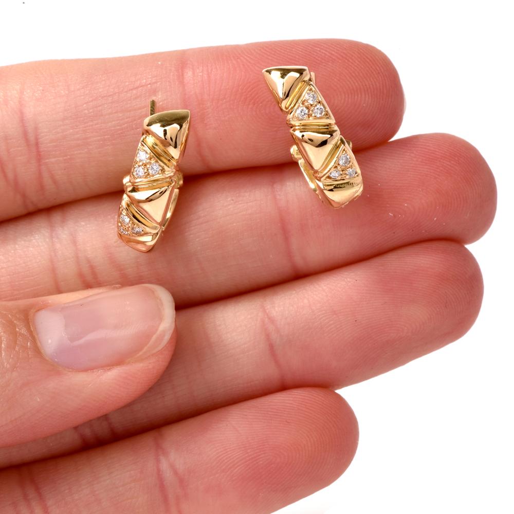 These delicate estate clip-on earrings with diamonds are crafted in solid18-Karat yellow gold, weighing 7.3 grams  and measuring 20 mm long x 5 mm wide. Designed as gracefully convex plaques, the earrings depict an assemblage of inversely juxtapose