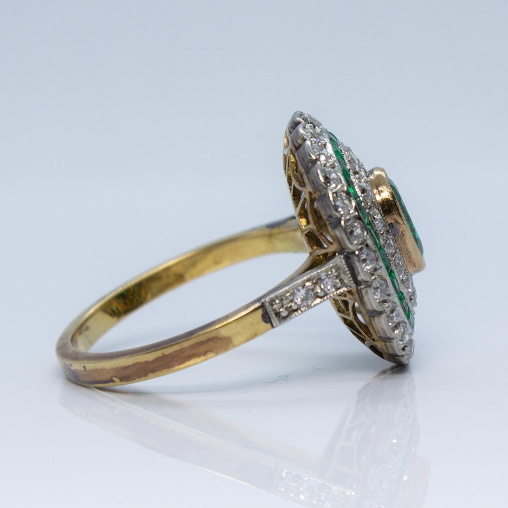 
Composition: 18K gold and platinum

Stones:
·1 natural cushion cut emerald that weighs 0.75ctw.
·44 Old mine cut diamonds of G-VS2 quality that weigh 1ctw.
·22 natural calibrated cut emerald that weigh 0.50ctw.

Ring size: 7 ½  
Ring face:  18mm by
