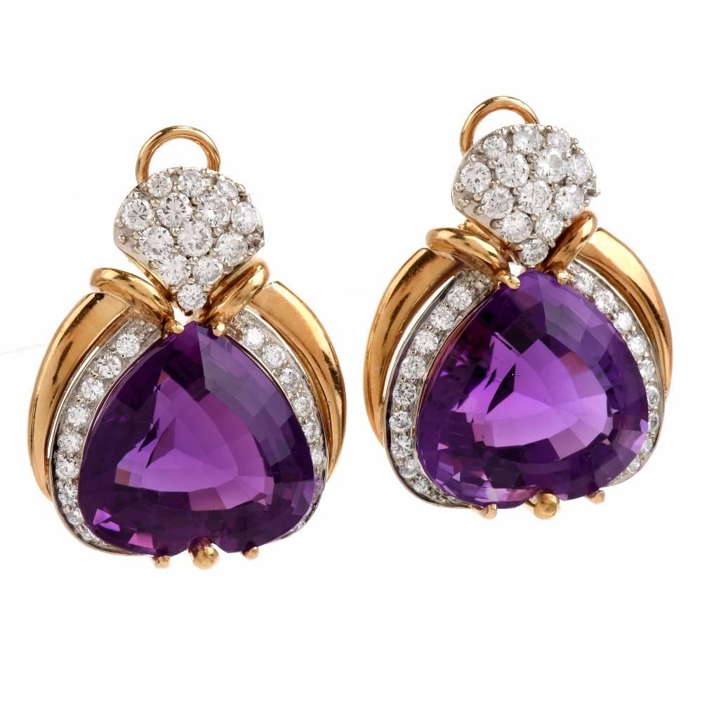 These estate 1980's Earrings of opulent and vivacious aesthetic and romantic inspiratin are crafted in solid 18karat yellow gold, weigh 35.5 grams and measure 35 mm x 30 mm. These earrings expose a pair  of translucent heart shape amethysts of vivid