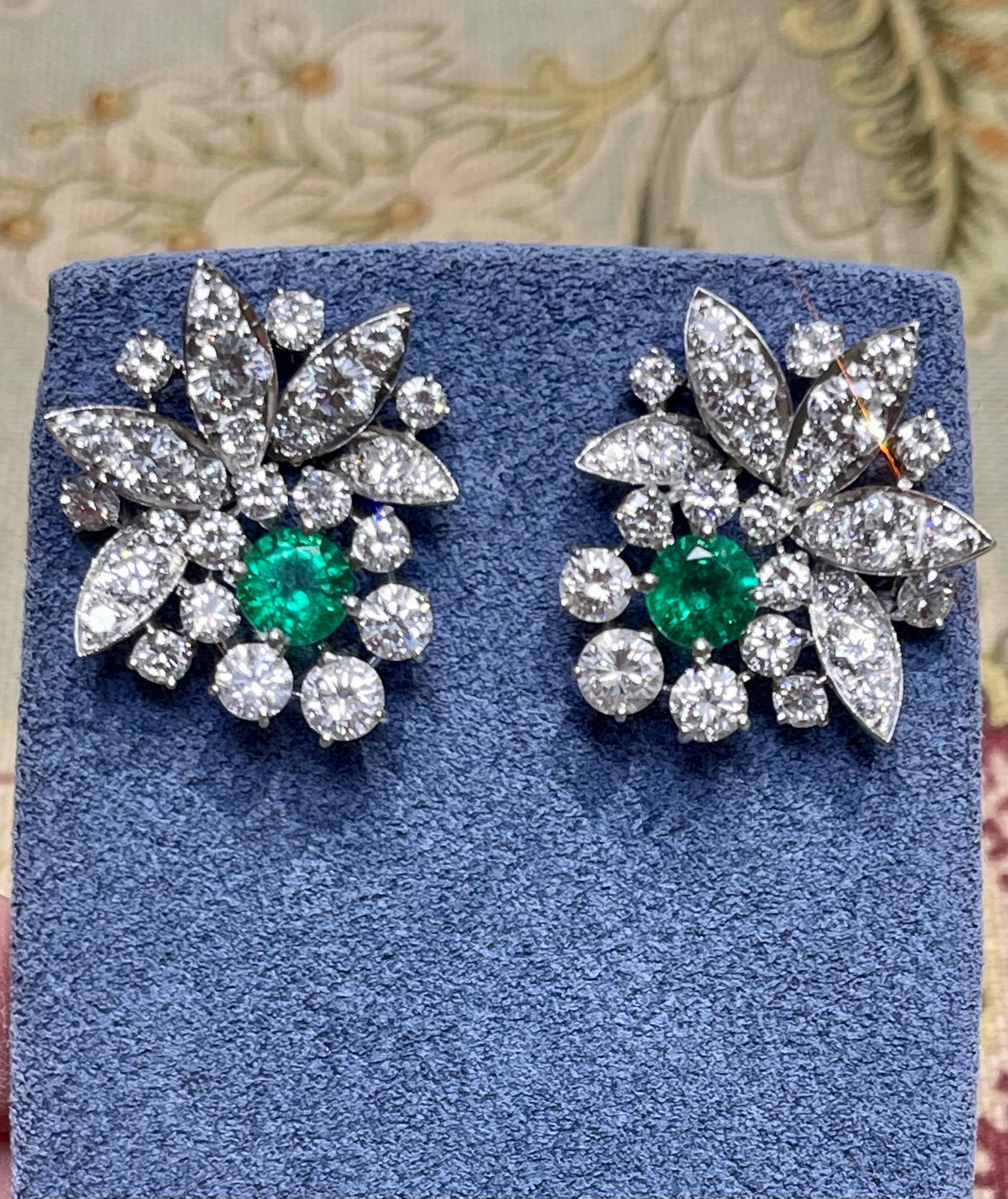Enchanting and luxurious, these old Hollywood style earring are a must have.
These radiant green Zambian emeralds shine at the center, surrounded by 54 sparkling diamonds. 
Each earring has a large backing to keep them hanging straight on your