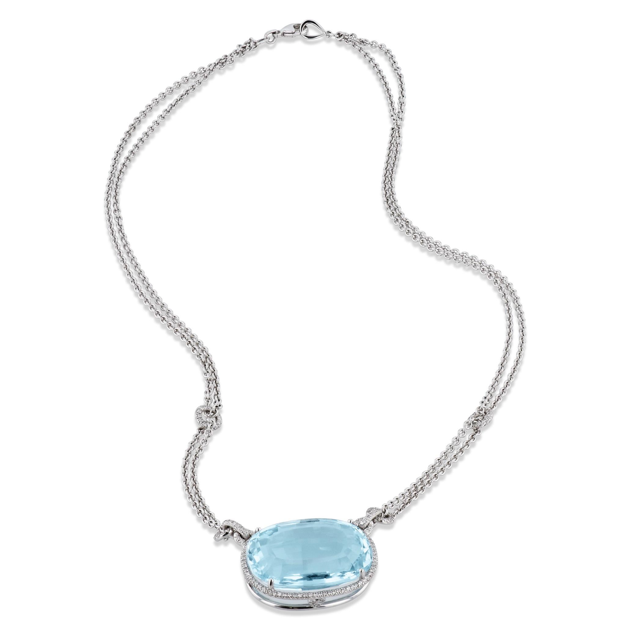 This stunning 18 karat white gold necklace features a 45.60 carat aquamarine surrounded by a halo of diamonds. There are a total of 186 round brilliant cut diamonds with a total weight of 0.56 carats that are H in color and VS1 in clarity. The large
