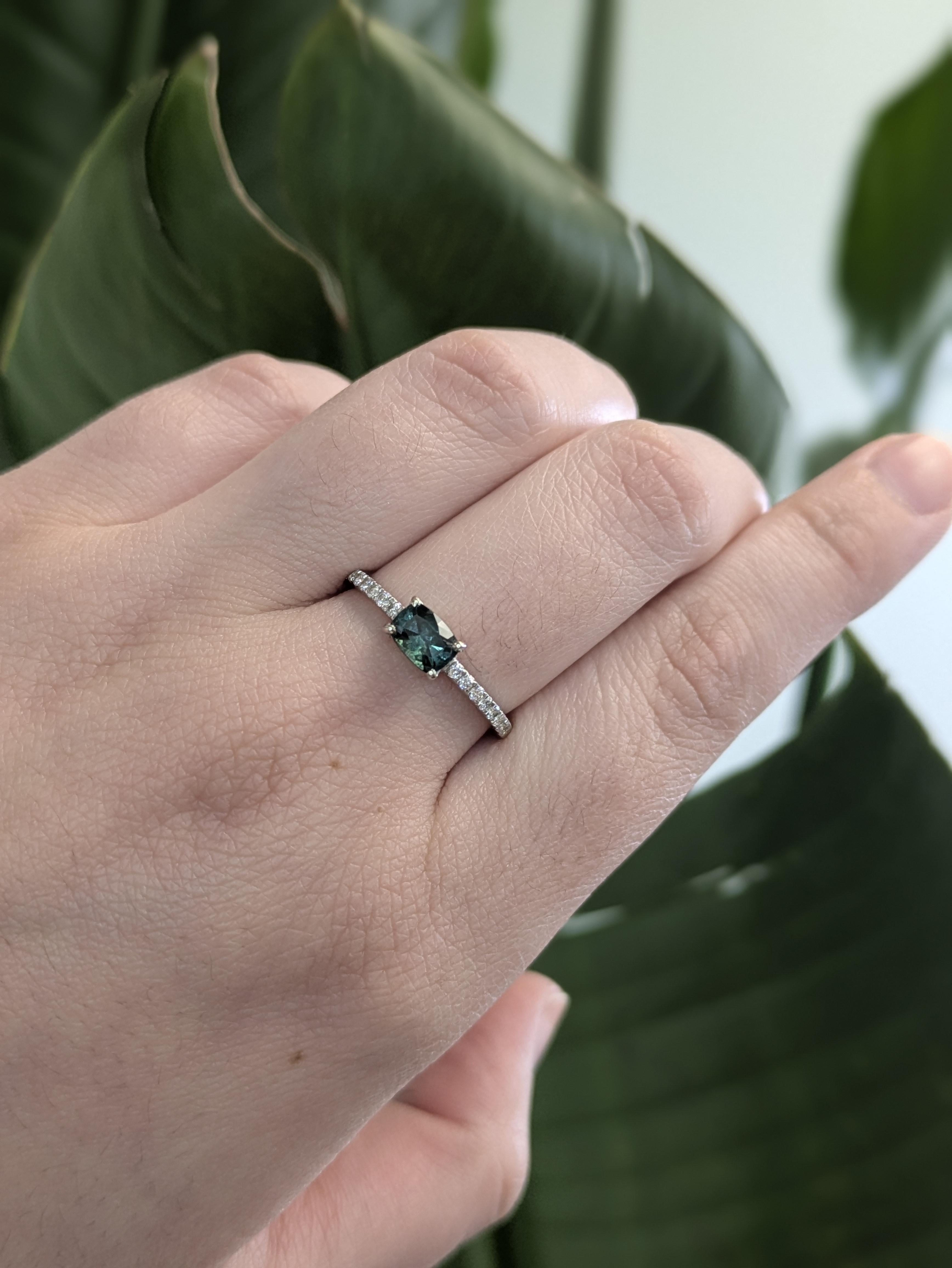 Featuring a 0.61 carat cushion-cut indicolite tourmaline in an eye-catching east-west setting, this Estate ring is elevated by a delicate pave diamond shank made from solid 14k white gold. An elegant and refined design perfect for everyday luxury or