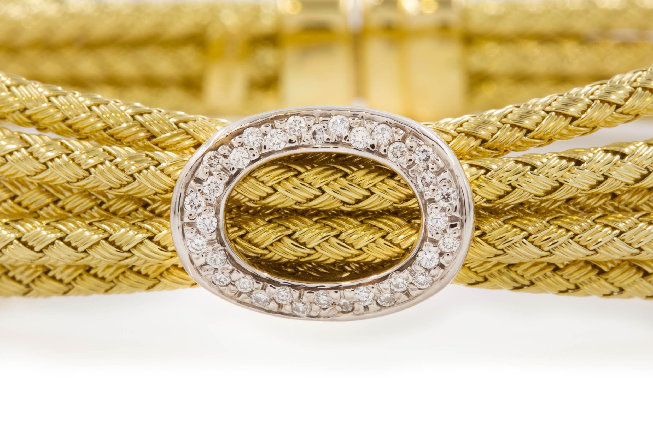 ESTATE ITALIAN 14K YELLOW GOLD FIVE-CABLE BRACELET
With circular white gold motif set with 32 diamonds; 27.8 grams total weight
Item # C104208 

A gorgeous Italian 14 karat yellow gold five-cable bracelet with a white gold circular motif set with 32