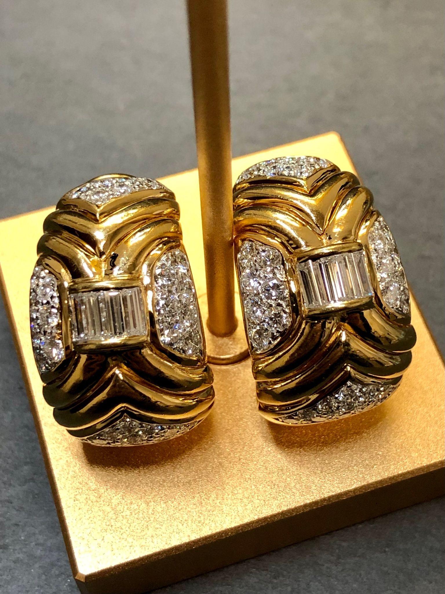 Beautifully made 18K huggie earrings channel set with large baguette and pave diamonds. Total approximate diamond weight is 4.50cttw and all stones are G-I color and Vs1-2 clarity diamonds.

Dimensions/Weight
1.1” long by .6” wide. Weighs