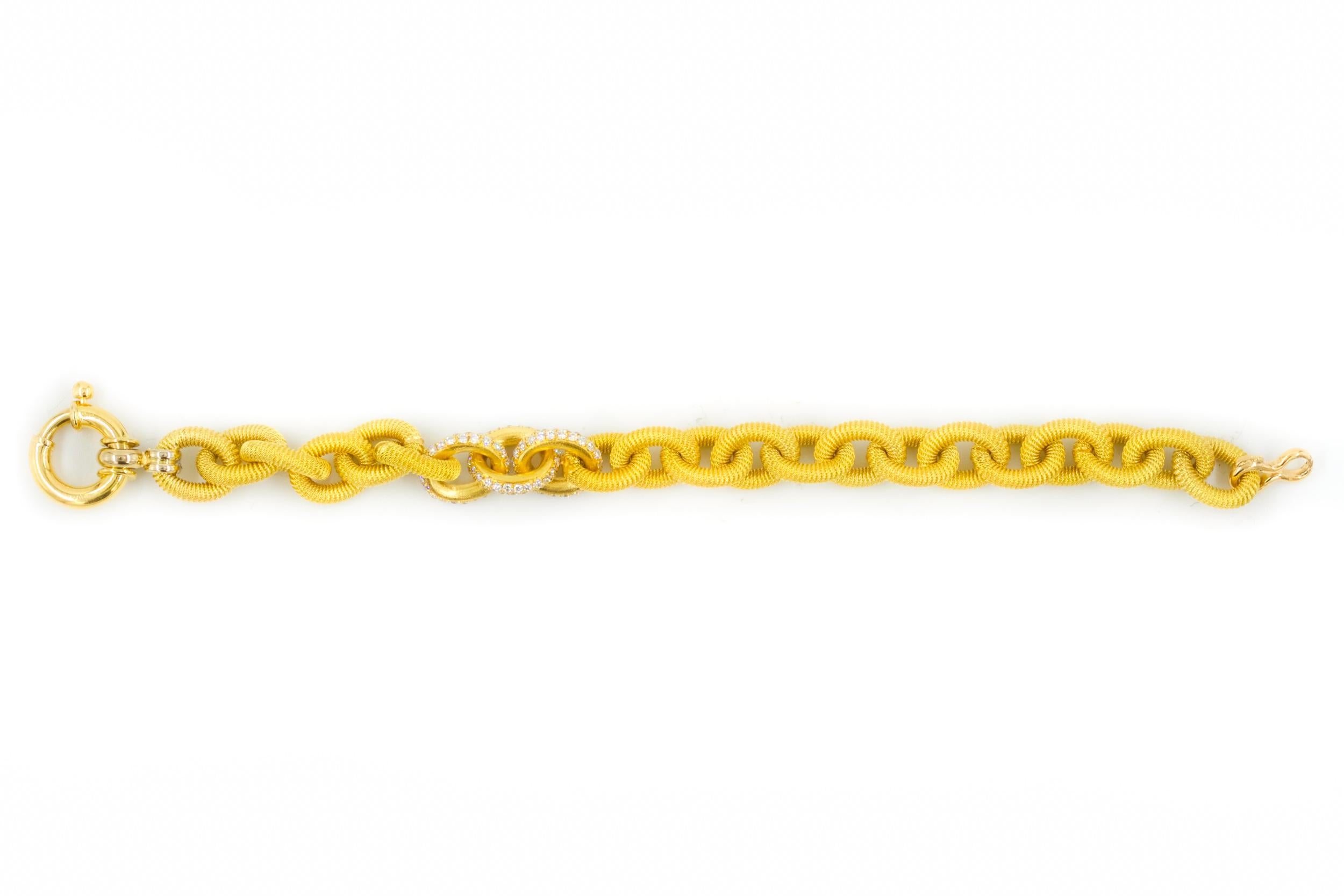 Just magnificent! This gorgeous estate 18 karat Italian yellow gold open-link bracelet is characterized by a ribbed and textured link surface with an overall matte finish; three links are set with 138 brilliant round-cut diamonds in a continuous