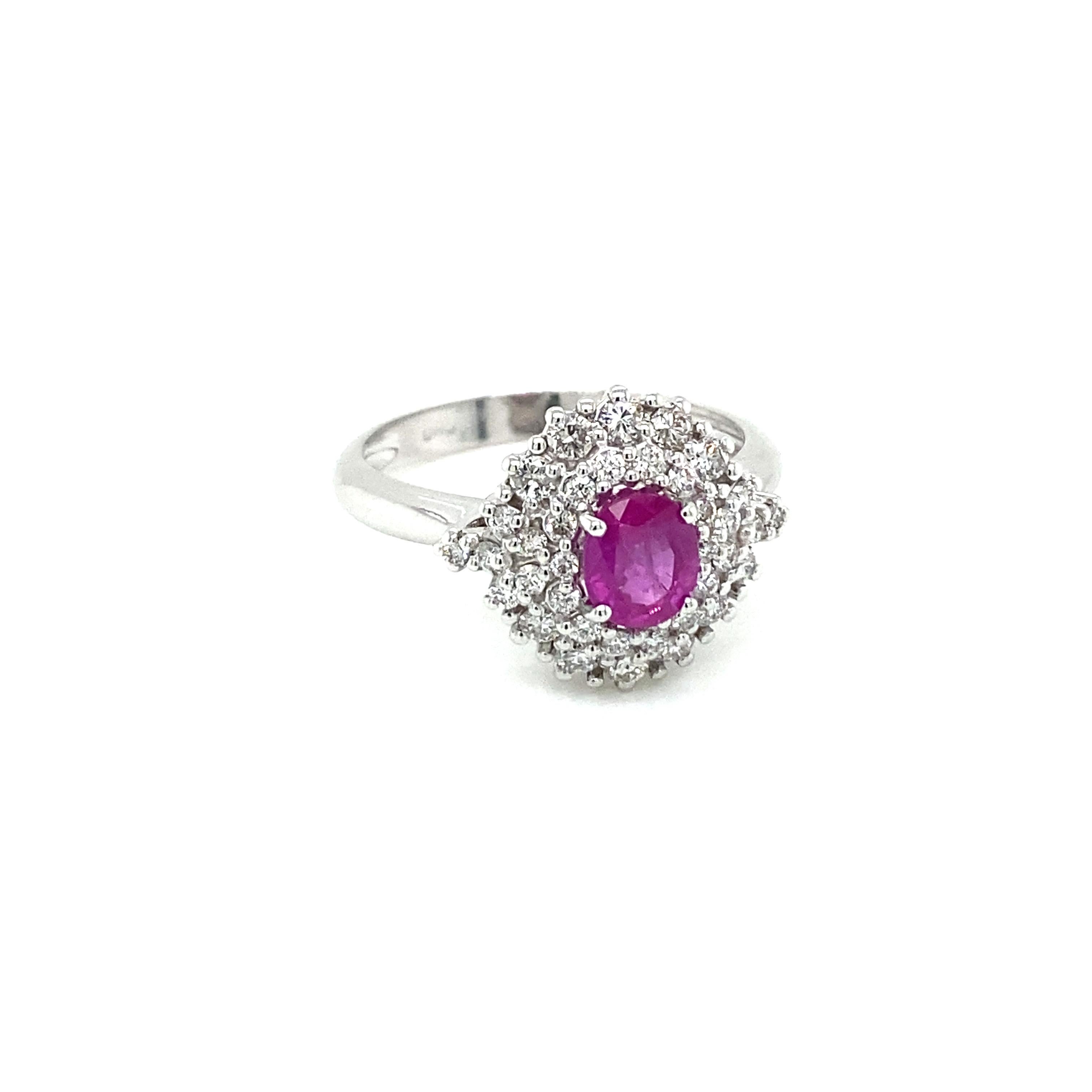 Elegant 18k white Gold, Ruby and Diamond cluster Ring.

It is set in the center with a Bright oval-cut Natural Ruby weighing ,80 carats of extraordinary color and clarity, flanked by sparkling Round Brilliant cut diamonds weighing 0,62 carats,