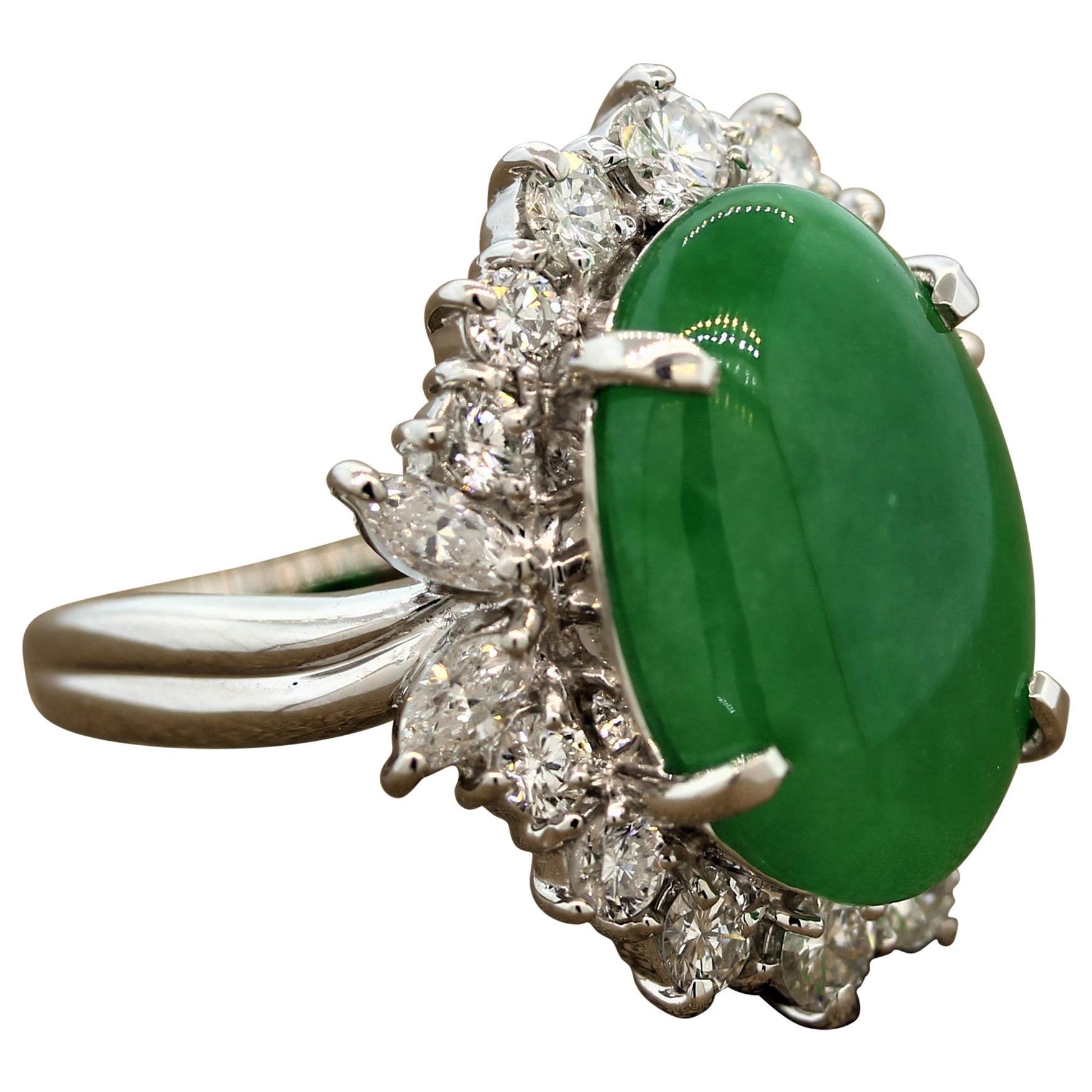 This alluring ring features an oval cabochon jadeite jade surrounded by a halo of 1.62 carats of diamonds in a platinum setting. The colorless round cut and marquise cut diamonds gleam with exuberance making this ring as exceptional as it is