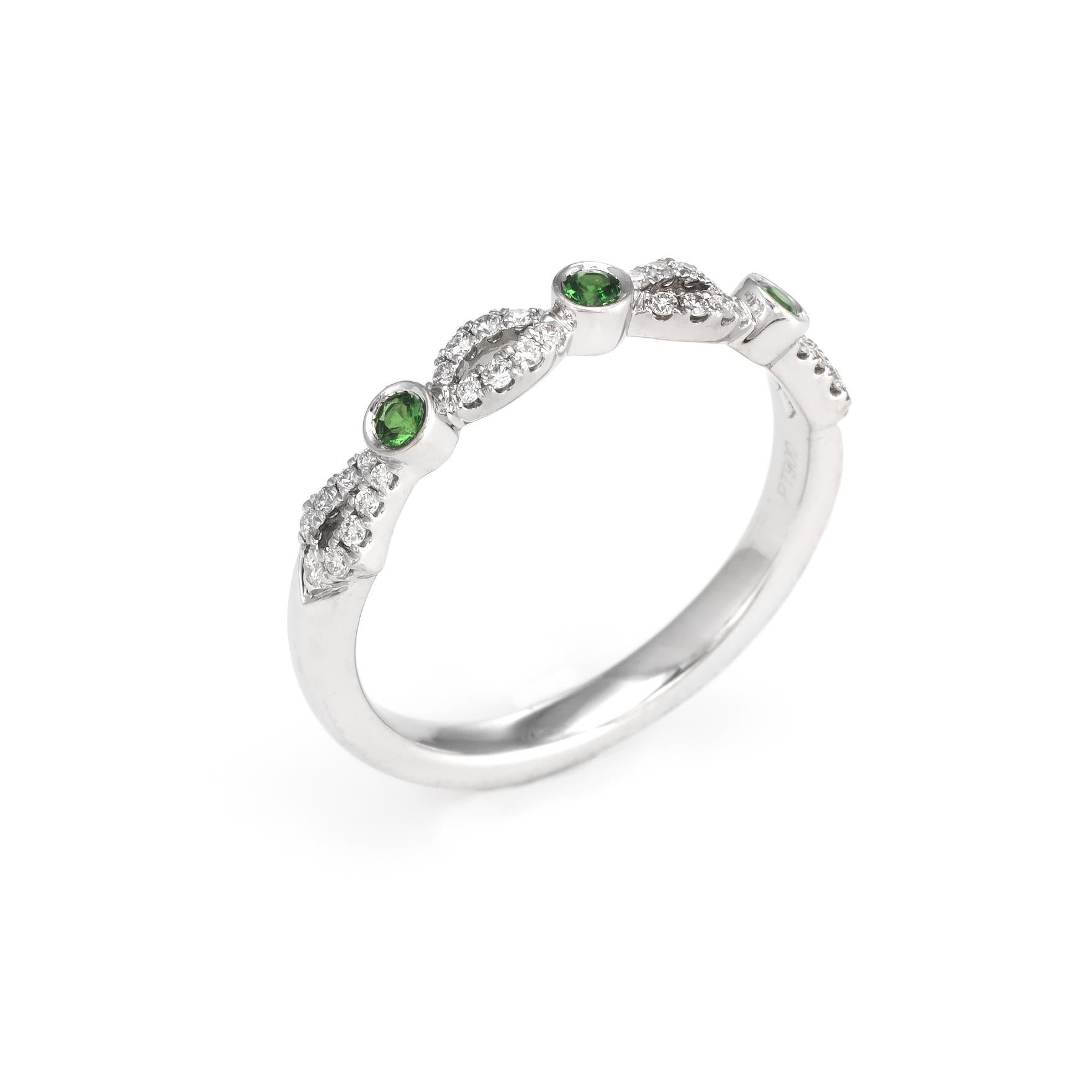 Finely detailed estate Kirk Kara ring, crafted in 900 platinum. 

34 round brilliant cut diamonds total an estimated 0.17 carats (estimated at G-H color and VS2 clarity), accented with three estimated 0.02 carat tsavorite green garnets (0.06 carats