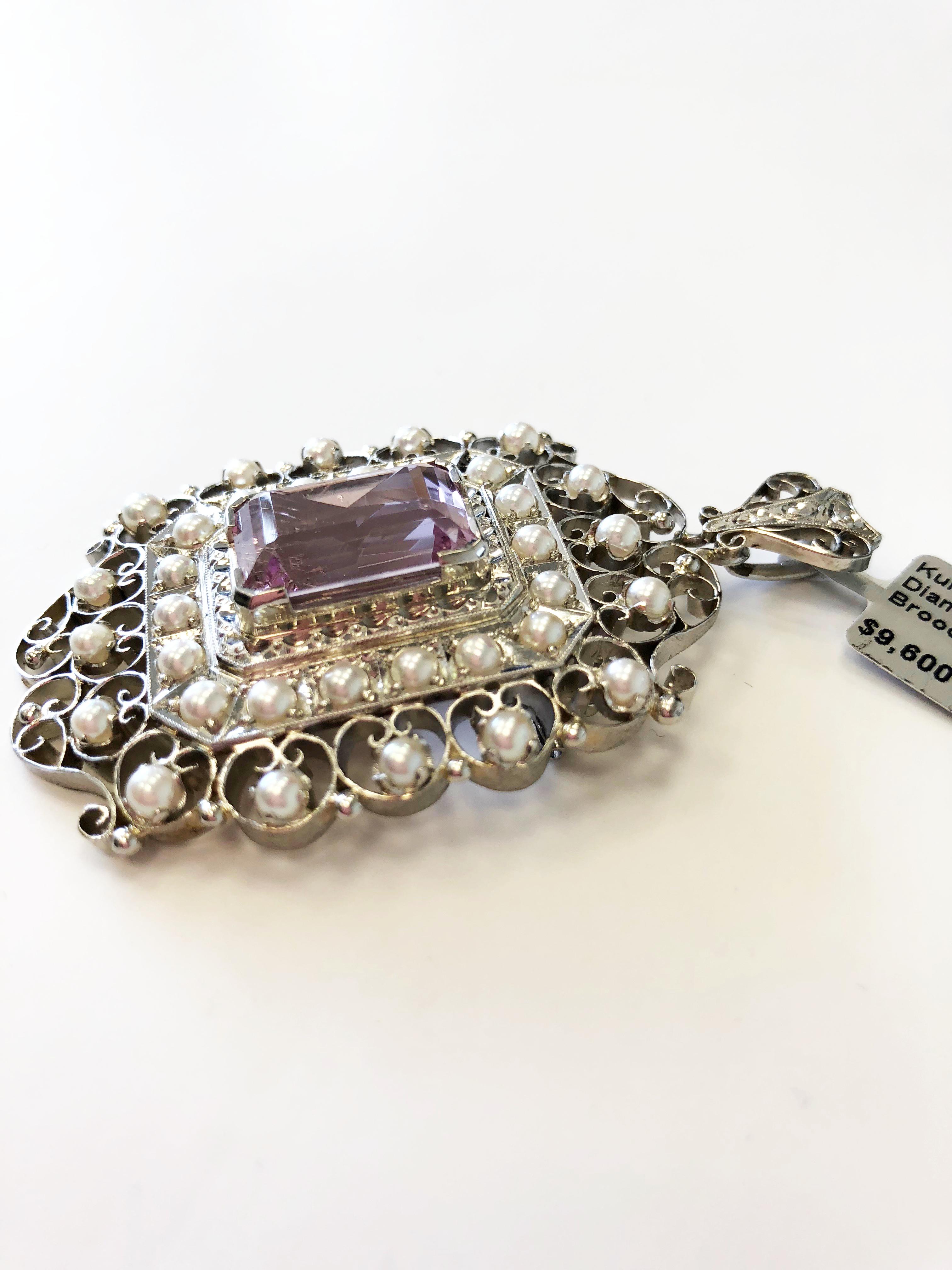 Unique pendant/brooch featuring a beautiful pink emerald cut kunzite, white diamonds, and round pearls. Because of the estate nature of this piece, no firm carat weights can be determined. Diamond quality looks good and bright. Kunzite is clear with