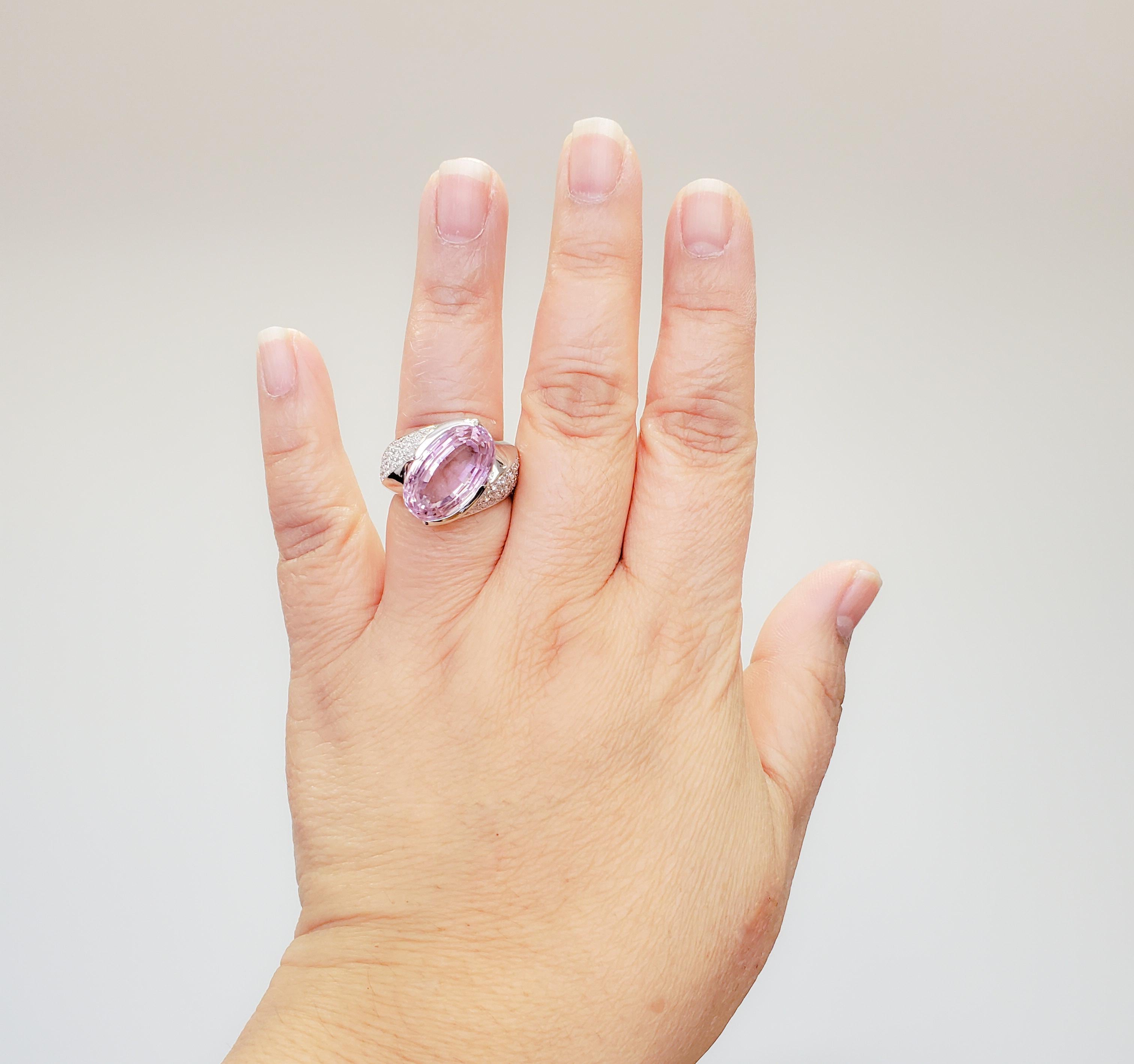 Gorgeous ring showcasing 11.00 ct. kunzite oval with a nice pink color.  Accent stones weigh 0.88 ct. and are good quality, white, and bright diamond rounds.  Handmade 18k white gold mounting in size 8.5.  Excellent condition.