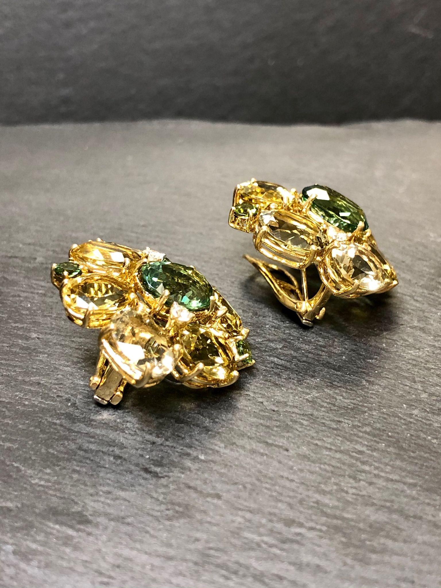 A large pair of statement earrings done in 18K yellow gold and set with various sized citrine, peridot and green quartz gemstones as well as .40cttw in G-H Vs clarity diamonds. These earrings are matched to a gorgeous cocktail ring also located on