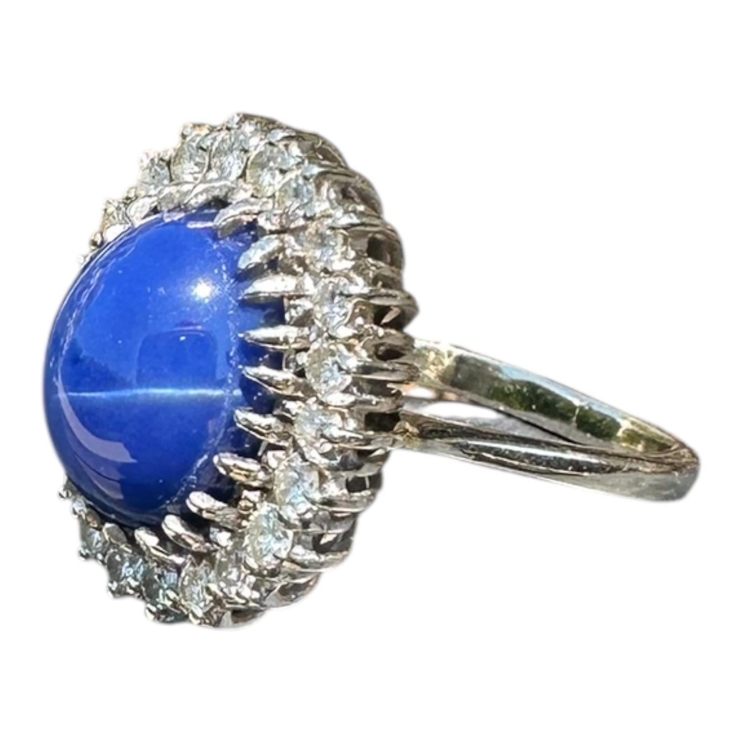 Este Gran Anillo Estate de Zafiro Azul Estrella y Halo de Diamantes de 0,90 ct en Oro Blanco de 18 quilates es una impresionante pieza de alta joyería perfecta para ocasiones especiales como compromisos, aniversarios o cumpleaños. El anillo tiene