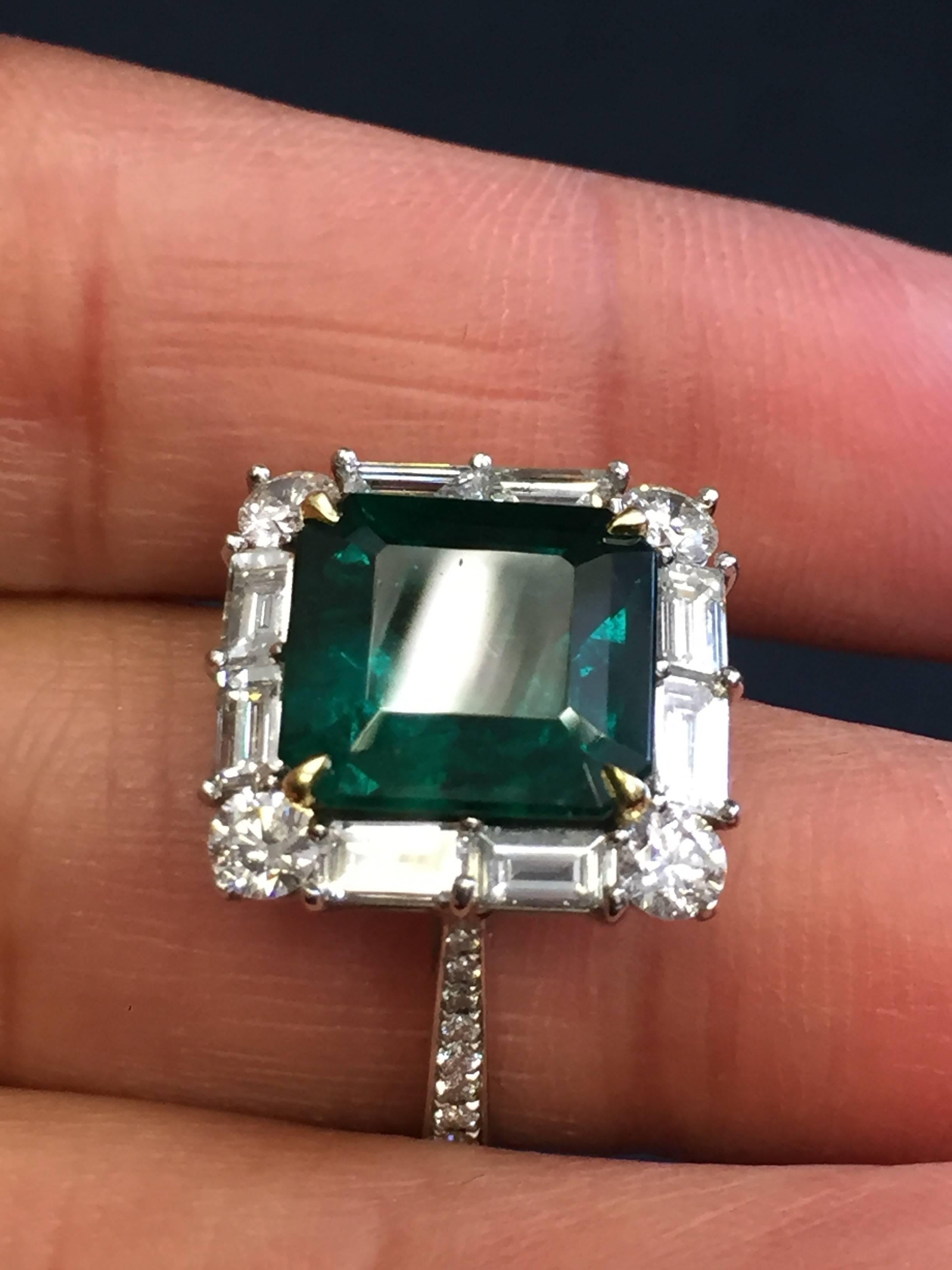 Gorgeous estate 4.93 carat emerald cut emerald with 1.67 carats of white diamonds in multi-shapes in a platinum mounty.  This ring is a dainty statement piece.  Ring size 6.25 with AGL lab report.