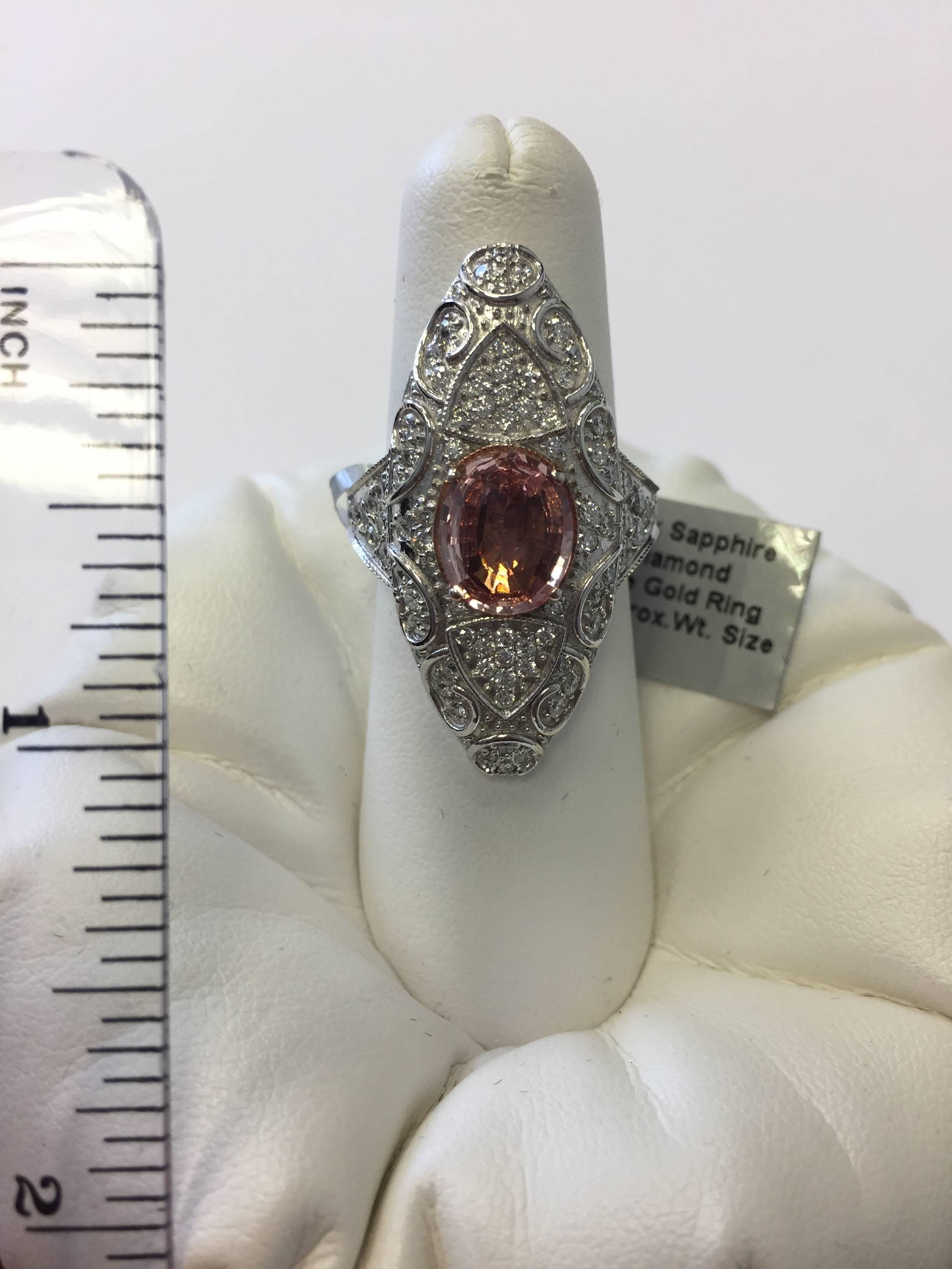 Stunning 2.32 ct pink sapphire oval with 1.25 ct white diamond rounds in 18k white gold in this estate inspired look.  Size 5.5