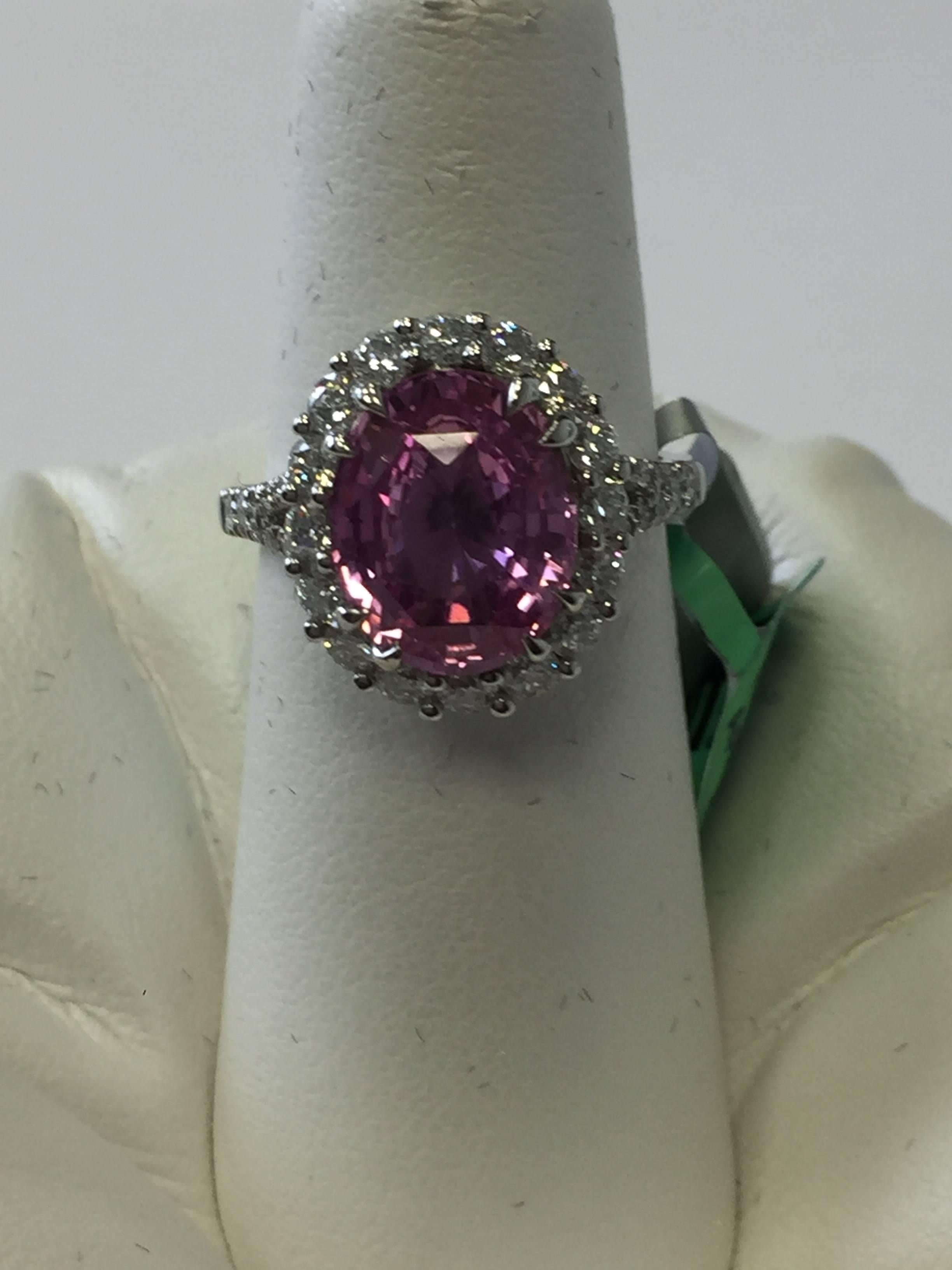 Gorgeous 4.73 carats Madagascar pink sapphire oval surrounded by 1.11 carats of diamond rounds.  This platinum estate cocktail ring is size 6.5 and comes with an AGL lab report.  A beautiful addition to any collection!