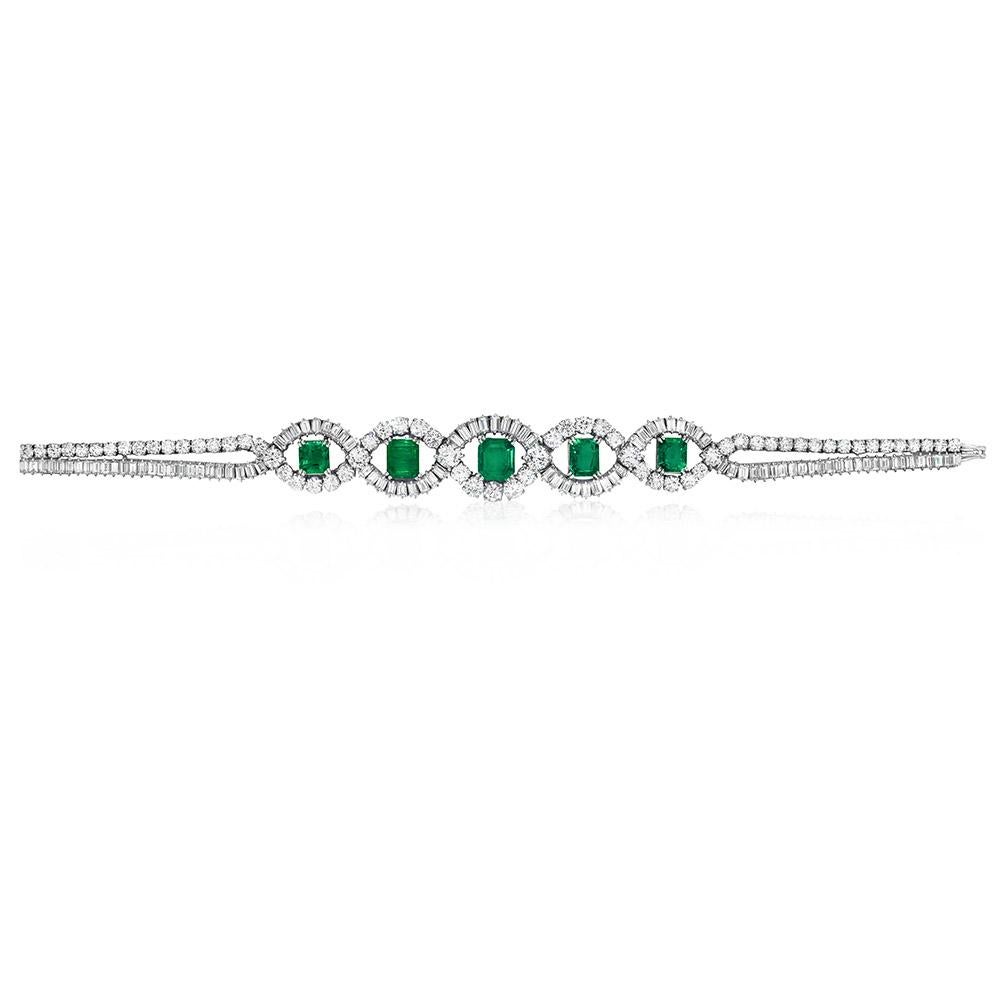 This Estate bracelet by Mellerio features five stunning Emerald-cut Emeralds float within a braid of baguette and round brilliant-cut Diamonds, in a platinum setting. This unique bracelet was designed by the French jewelry house Mellerio dits