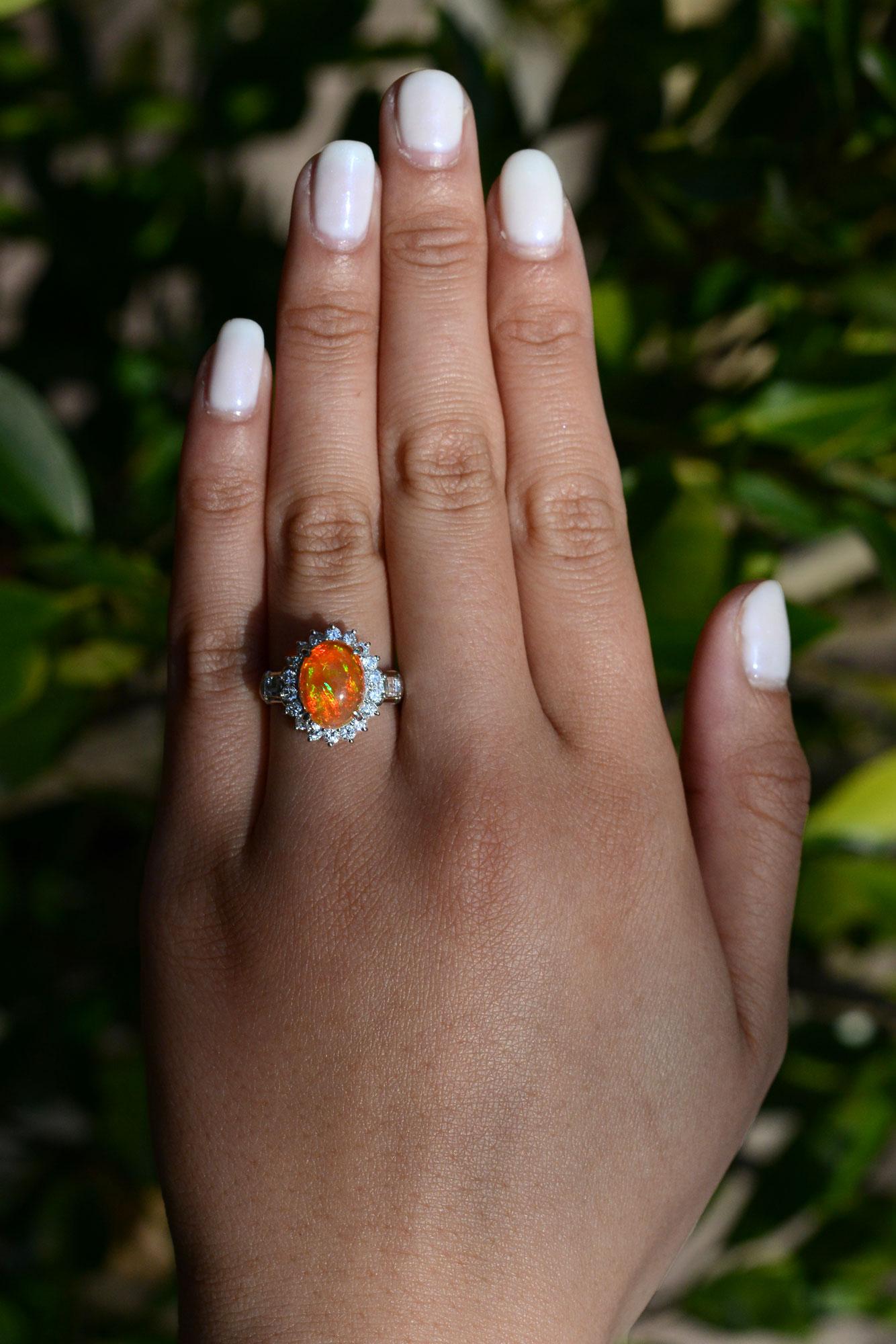 An amazing, vibrant cocktail ring displaying an incredible Mexican fire opal with a blazing orange background color and intense flashes of red, green, and yellow. Said to bring positivity and confidence to its owner, is a rare and phenomenal